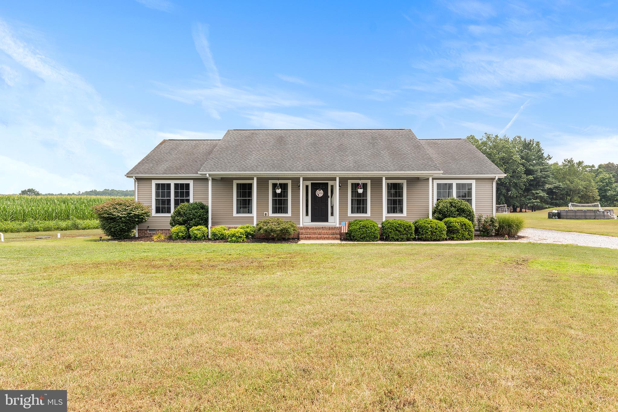 Welcome to this well-maintained 4-bedroom, 2.5-bath detached home in Delmar, DE, offering comfortable one-level living with no interior stairs. Situated in a peaceful rural setting, this property combines open space and convenience with easy access to Route 13, minutes from Salisbury University and easy access to the Delaware and Maryland beaches. 

Inside, the open floor plan creates a seamless flow between the main living areas, enhanced by recessed lighting throughout. The spacious kitchen is designed for both everyday living and entertaining, featuring stainless steel appliances, wood cabinetry, breakfast bar seating, abundant storage, and generous counter space for meal preparation.

The primary suite offers a relaxing retreat with a large walk-in closet and an attached bathroom featuring a double vanity. Three additional bedrooms provide flexibility for a variety of needs. A finished laundry room adds functionality and extra convenience.

Outside, enjoy expansive rural views as the property backs to a cornfield, creating a sense of privacy and open space. The large yard offers plenty of room for outdoor gatherings, recreation, and enjoying the surrounding scenery. Car enthusiasts, hobbyists, or those needing additional storage will appreciate the detached garage with space for up to five vehicles, along with ample driveway parking for guests and additional vehicles.