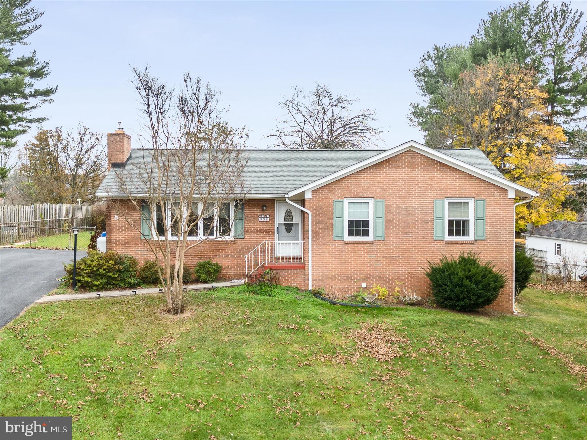 Nestled in the desirable Tuscawilla Hills community of Charles Town, this charming 3-bedroom, 3-bathroom full brick rancher offers an inviting blend of comfort and convenience. Enjoy the elegance of hardwood floors throughout the foyer, living room, and all bedrooms. The living room features a cozy gas fireplace, creating a warm and welcoming atmosphere. The open kitchen and dining room combo provide an ideal space for entertaining, with easy-care vinyl flooring. Downstairs, the fully finished lower level boasts a spacious rec room, a full bathroom, a versatile bonus room, and a huge laundry and storage area—perfect for extra living space or hobbies. Sitting on a third-acre lot, this property offers a large, fenced backyard, providing both privacy and space for outdoor enjoyment. There is also plenty of driveway parking for guests. This move-in-ready home is perfect for those seeking both relaxation and practicality in a peaceful neighborhood. Don't miss out—schedule your tour today!