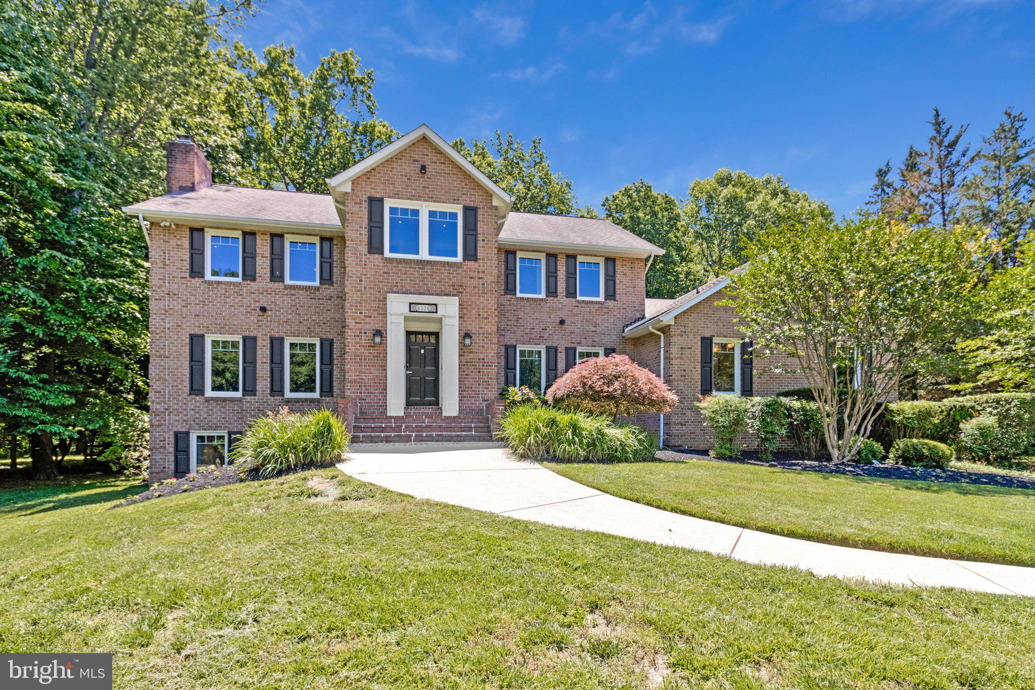 Welcome to this breathtaking all-brick custom colonial nestled in the coveted Highland Lakes community. Perfectly positioned on a serene, professionally landscaped 1.08-acre cul-de-sac lot backing to mature trees, this exceptional estate offers a rare blend of timeless elegance, modern comfort, and forward-thinking sustainability. Inside, an expansive open floor plan showcases gleaming hardwood floors, striking crown moldings, soaring 9’+ ceilings, and beautifully renovated finishes throughout. Designed for both grand entertaining and everyday living, the main level features a massive great room with beamed ceilings, an entry-level bedroom with a private ensuite, and an entertainer’s dream kitchen complete with dual sinks, two refrigerators, two dishwashers, an induction cooktop, double wall ovens, a wet bar, and a sun-filled breakfast area. The newly added four-season sunroom seamlessly blends indoor comfort with the beauty of the surrounding landscape. Step outside to your own private backyard retreat featuring an automated saltwater pool, scenic wooded views, and a low-maintenance composite deck perfect for entertaining. The home is also future-ready with a Tesla solar roof, dual Tesla Powerwalls for backup power, and a dedicated EV charging port in the garage. Upstairs, the luxurious primary suite offers spacious custom closets and beautifully updated spa-like baths. The fully finished lower level includes a complete in-law apartment with independent ground-level walkout access, ideal for multi-generational living, guests, or an au pair suite. Laundry is conveniently located on every level of the home. Beyond the property itself, this home offers the rare opportunity to own in one of Maryland’s most sought-after locations. With low annual HOA fees, easy access to both Baltimore and Washington, D.C., and a tranquil park-like setting, this thoughtfully renovated residence offers an exceptional place to call home. Adding even more appeal, the home is zoned for the highly acclaimed Howard County Public School System, feeding into Dayton Oaks Elementary, Lime Kiln Middle School, and the top-rated River Hill High School.