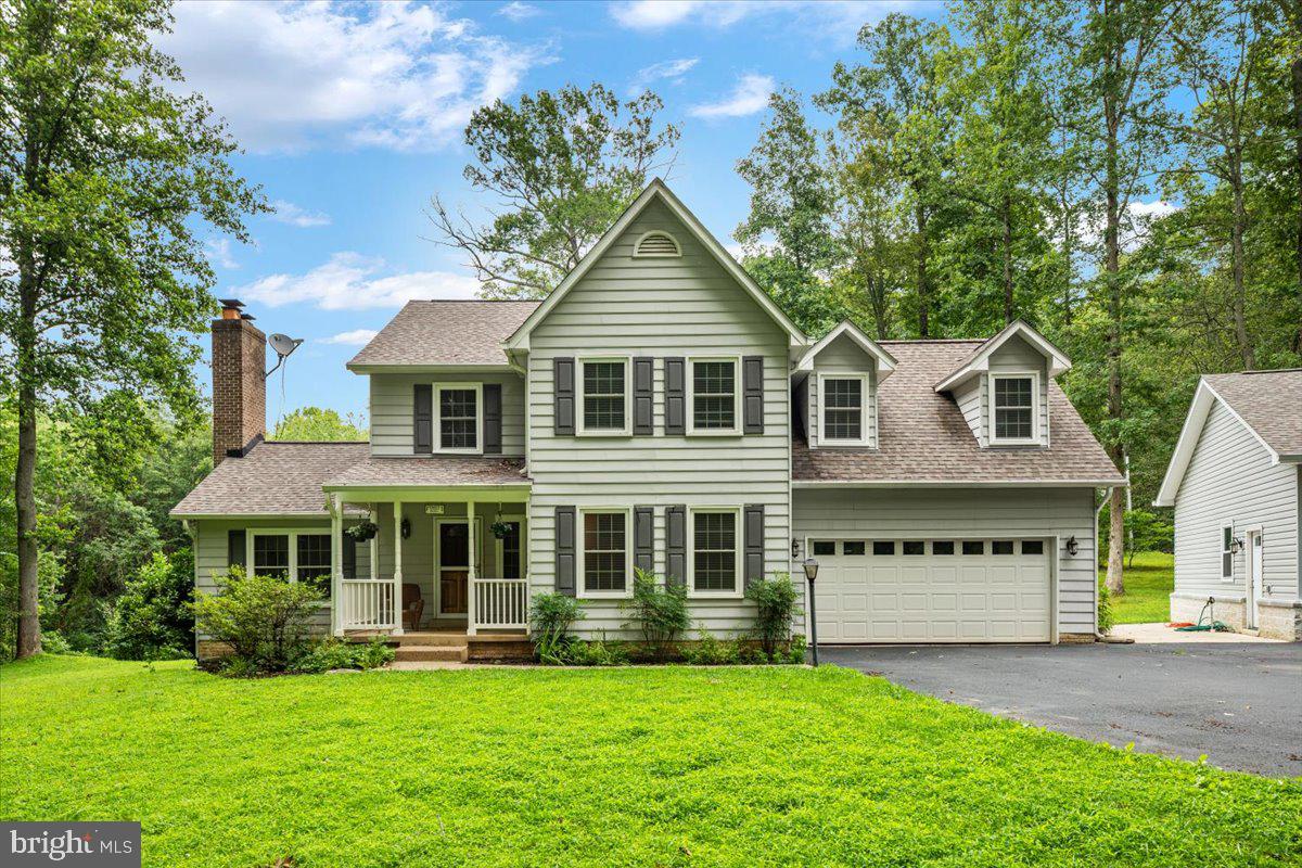 Welcome home to this incredible Woodbine Forest retreat, where privacy, space, and natural beauty come together on a breathtaking 5-acre cul-de-sac lot complete with a peaceful stream on the property!

This spacious 4-bedroom, 3.5-bath home offers room for everyone with an inviting layout designed for both everyday living and entertaining. Step into the dramatic living room featuring soaring cathedral ceilings and a beautifully updated fireplace that creates the perfect gathering space.

The kitchen was tastefully updated in 2023 and is complemented by newer flooring throughout the main level, while the basement received brand-new flooring in 2026, making this home ready for its new owners. Enjoy your morning coffee or unwind after a long day on the screened porch as you take in the sights and sounds of the surrounding nature.  Additionally, enjoy peace of mind knowing that the roof, hot water heater, and windows, were all replaced within the last 4 years.

One of the property's most impressive features is the detached 3-car 30 x 30 detached garage with AC, built in 2023 with an investment of approximately $100,000; perfect for car enthusiasts, hobbyists, additional storage, or a workshop.

From the abundant living space to the stunning outdoor setting, this home offers the perfect blend of comfort, functionality, and peaceful country living while still being conveniently located. Opportunities like this don't come along often!  Schedule your private tour today!