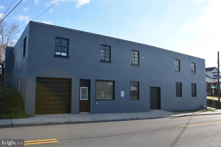 This versatile commercial property offers nearly 13,000 square feet of usable space, ideal for a wide range of business needs. Once utilized as an office, sheet metal fabrication, and warehouse for a local plumbing and heating business, the building features two floors, two bathrooms, and three convenient drive-in doors. Situated on a corner lot, the property boasts a roof installed in 2021. With its flexible layout and strategic location, this property presents endless possibilities for businesses looking to get started or expand.