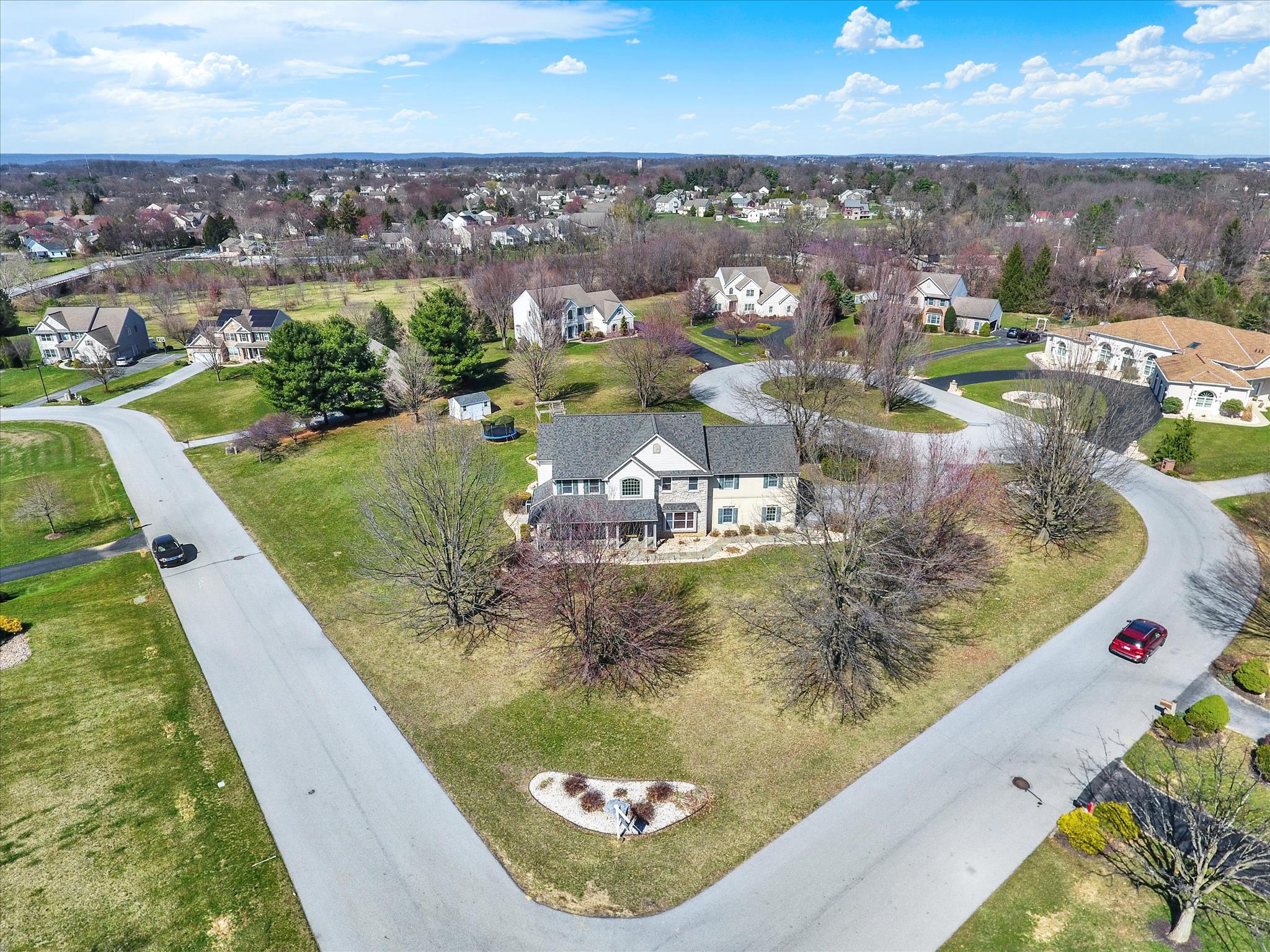 Multigenerational possibilities exist in this truly unique home that offers great style and versatility.  2-Story entrance, formal dining room and reading room/library are just a glimpse of the multiple living areas. The well-appointed kitchen is a chefs dream and boasts a large granite island, gas range and custom wooden cabinets.  Serving as the heart of the home, the kitchen overlooks a large dining area, the great room area and the game day room that's equipped with a wet bar and numerous TV's for your enjoyment.  Doors lead to the extensive back yard area and wrap around porch to enjoy the pleasant surroundings. Upstairs you will find an expansive owners suite with space for a reading nook and desk,  bath with an upgraded high end tile shower and a large spa-like tub. Three more bedrooms and bath complete this area and overlooks the open foyer.  If you want to give guests their own private suite, the bonus room is the 5th bedroom with a full bath and a private entrance .  Once used as an art studio, this area could be used as a gym, dedicated office suite, or a comfortable retreat from stressful days. The lower level is also finished with a game room, and additional flex room for all your creative needs and offers a daylight entrance.  Once outside you will find a thoughtfully hardscaped setting, complete with a firepit, and pavilion -- so simple to relax and unwind.   Additional mentions include a NEW roof,  gas generator, new gutters plus an electric vehicle outlet in the garage. Location is key -- close to Hershey Medical Center, Rts 322, 72, and the PA Turnpike.   Pool, tennis and clubhouse rounds out the carefree amenities available. Call today for your  private showing.