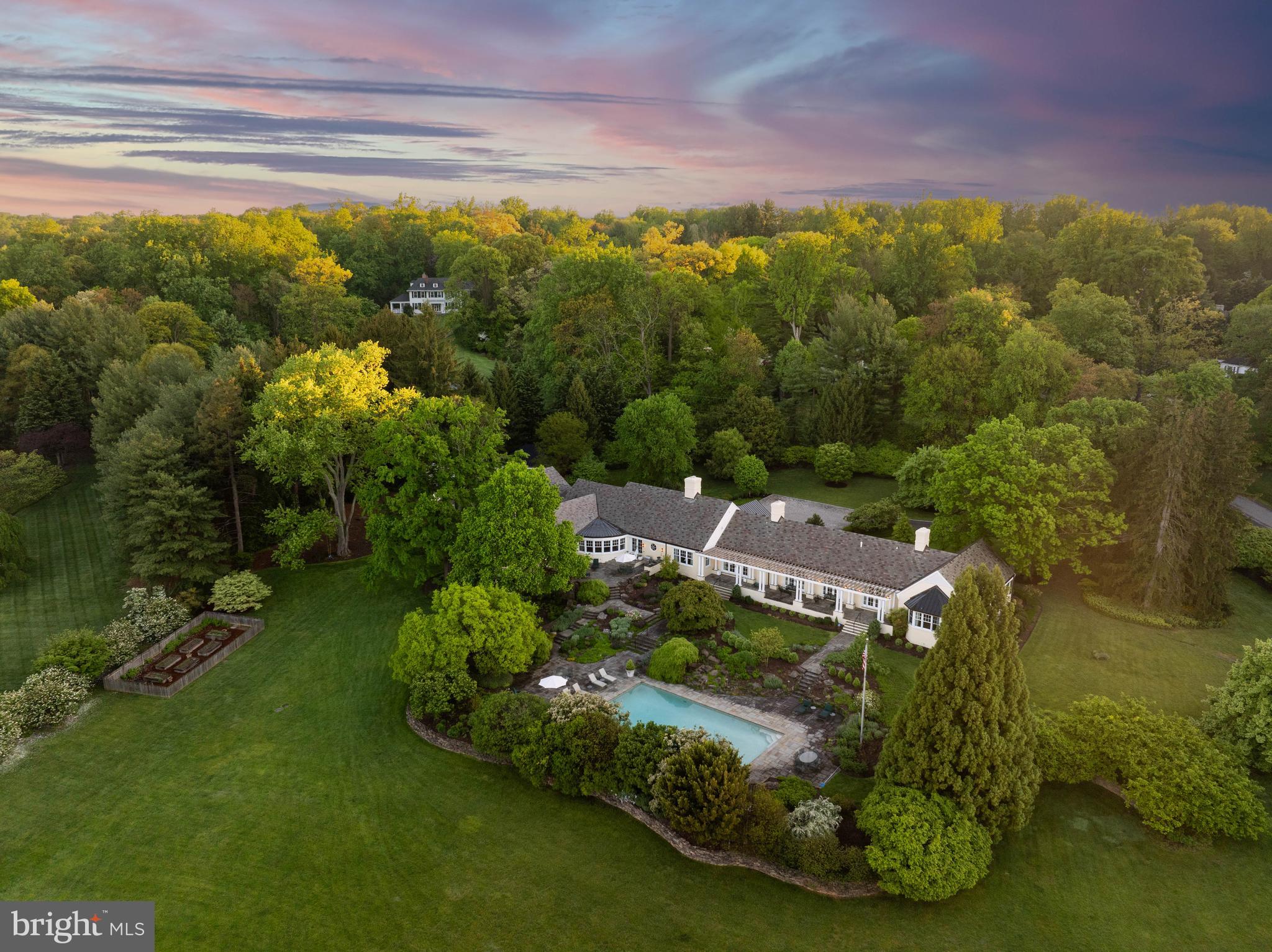 Live authentically. A sumptuous estate in Greenspring Valley's lifestyle enhancing Golf Course Road community. Enduring quality finishes. Designed by Gene Gillespie. Glorious Stiles Colwill interiors. An enchanting reveal. Be greeted by a grand cobblestone motor court. Multi-tiered outdoor living that reaches into the site effortlessly. Designed with a distinct Charleston aesthetic. Meandering stone loggias and covered porches all cascade gently to a magnificent fifty foot pool with textured artisan landscaping. Your dynamic outdoor vision brought to life. Seasonal plantings thoughtfully curated for maximum visual splendor. Gently nestled on an extremely private, 5.06 ac., premium golf course lot. Supreme livability.  Be welcomed by the long covered bluestone porch that beckons for relaxed afternoons. Swing open the signature mahogany door, and enter.
The foyer, a feast for the eyes, exquisite millwork, decorative plaster, human scale, masterful layering of texture, and light… you are drawn in to both pause and explore. And so it goes, delight as you meander from space to space. A breath of fresh air... your living space. Incredible ceiling height and walls of glass offer you expansiveness, natural connectivity, and seamless flow outdoors. The lightness of a holiday retreat permeates. Fully finished lower level that can serve as complete guest suite with full bath and easy on grade access or convert to a party barn/pool house…the possibilities are endless. Unrivaled mud room. Handsome butternut wood paneled destination library anchored by  fireplace with marble surround, ready for thought provoking conversations into the wee hours. Multiple studies. Designated wrapping room.  
A decorative dining room that celebrates life and all of our gatherings with ease and subtle grandeur. Hand painted walls by artist Bob Christian, in the perfect tone of energizing yet sophisticated orange. See sellers amenity list attached. Just minutes from everywhere you want to be. Cultivate your existence. The art of uniting human and home.