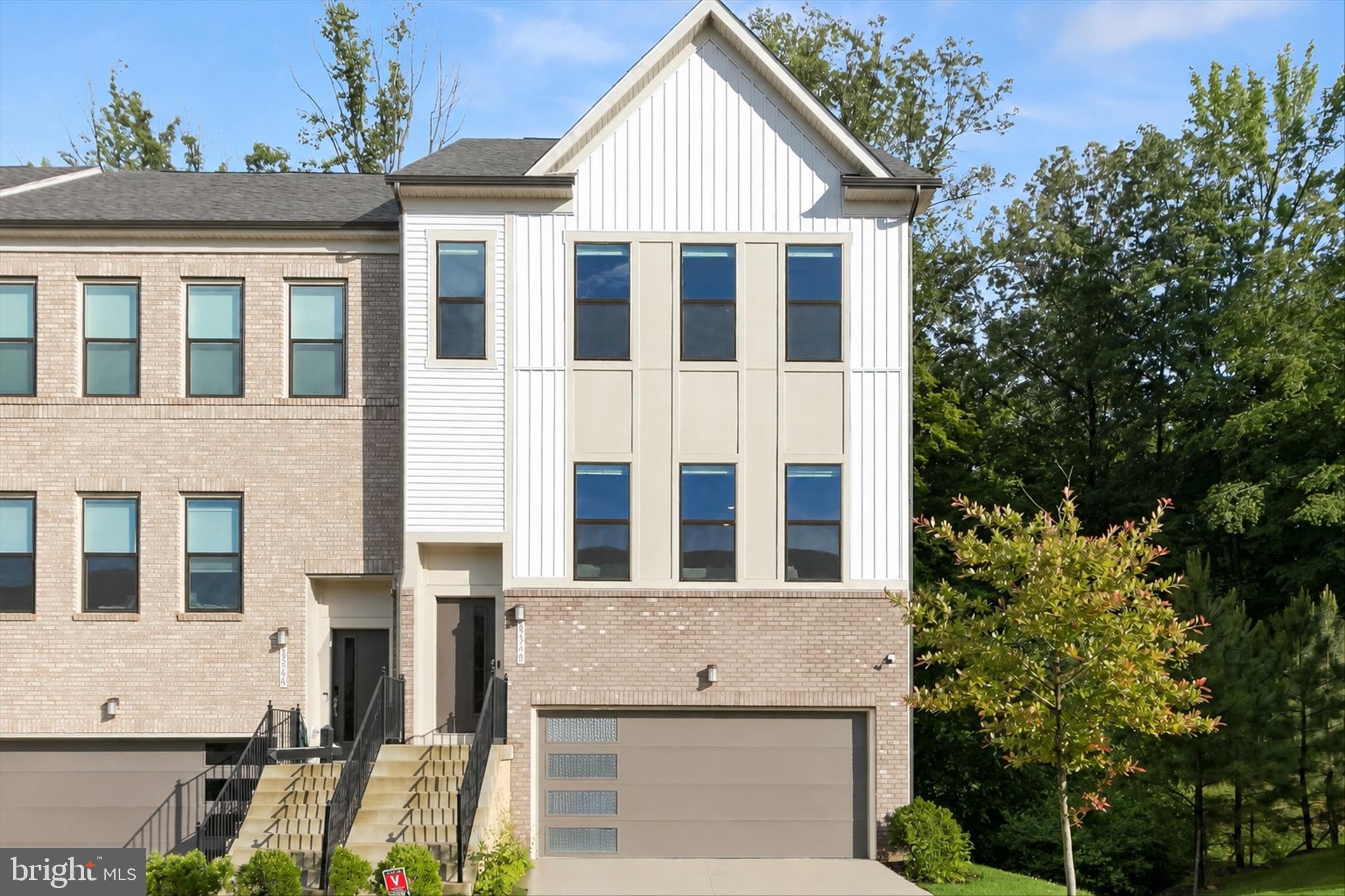Welcome to 3348 Watershed Boulevard, an upgraded Isleton model townhome situated on a premier builder-selected corner lot within the sought-after Watershed community of Anne Arundel County. Backing to protected open space near the Patuxent Wildlife Refuge, this exceptional homesite offers enhanced privacy, abundant natural light, and tranquil wooded views preserved from future development.

A bright split-foyer design welcomes you into a thoughtfully designed floor plan. The walk-out lower level features a versatile bedroom with a dual-entry en-suite full bath, ideal for guests, multi-generational living, or a private home office.

The open-concept main level is designed for both everyday living and entertaining. The gourmet kitchen showcases 42-inch white recessed-panel cabinetry, quartz countertops, a designer hexagon mosaic tile backsplash, stainless steel appliances, pantry storage, and a spacious center island with breakfast bar seating. Recessed LED lighting, pendant fixtures, and an undermount sink with pull-out sprayer complete the space. The adjoining dining area and living room create an inviting atmosphere, while the light-filled sunroom opens through sliding glass doors to a private deck overlooking the wooded backdrop.

Upstairs, the primary suite offers a spa-inspired bath with quartz vanity countertops, ceramic tile flooring, and a tiled shower with built-in seating. Two additional bedrooms, a full hall bath, and convenient bedroom-level laundry complete the upper level.

Additional highlights include a front-load attached two-car garage with storage space, remote-controlled ceiling fans in all bedrooms and the sunroom and low-E insulated windows,

Residents enjoy Watershed's exceptional amenities, including community centers, fitness facilities, swimming pools, dog parks, community gardens, playgrounds, and over 13 miles of scenic trails. Conveniently located between Washington, D.C., Baltimore, and Annapolis, with easy access to Fort Meade, NSA, BWI Airport, and major commuter routes.

Combining premium upgrades, protected natural surroundings, and resort-style community amenities, 3348 Watershed Boulevard offers the perfect blend of comfort, convenience, and contemporary living.
