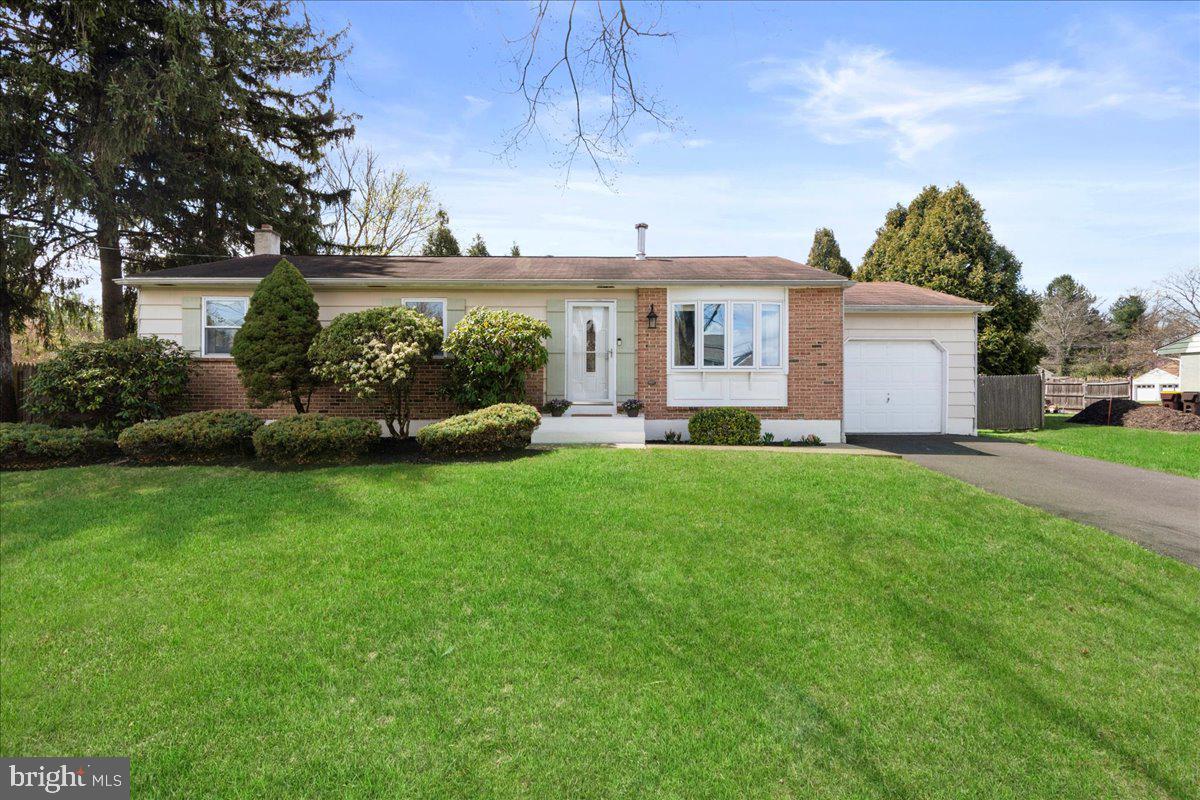 Welcome home to this charming rancher in Doylestown! This lovely, well maintained 3 bedroom, 2 full bathroom property offers the ease of one level living in a convenient and desirable Doylestown location. As you walk in the front door, you are greeted by the open, freshly painted neutral living room with wood floors and a wood burning stove. Down the hall you’ll find the spacious primary bedroom with an attached full bathroom. Adjacent to the primary bedroom are 2 additional bedrooms and a full hall bathroom. Rounding off the main floor is the kitchen, that offers wood cabinets, Corian countertops, tiled backsplash and a built-in island. Off the eat-in kitchen are sliding doors that provide access to the outdoor patio and the private, fenced in back yard perfect for children and/or pets. We can’t forget to mention the full, finished basement because it is HUGE! It includes an entertainment area, additional open play or workout space, sizable bonus storage closet, and a large laundry room. The one car garage offers ample storage space and a convenient back door for direct access to the back yard. The oversized driveway makes parking and entertaining friends and family easy! This move-in ready home is conveniently located close to downtown Doylestown, shopping and restaurants, major roadways and more!