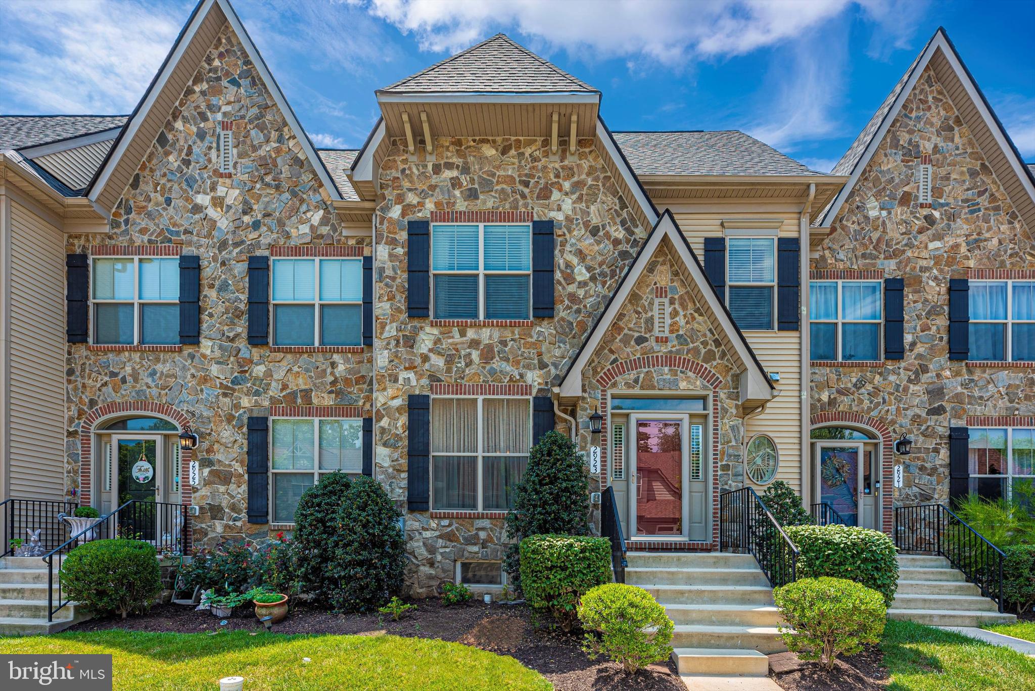 Beautiful Chateau style townhome in Mill Island at Worman's Mill. This beautiful home features 9 ft. ceilings and hardwood flooring throughout the main level. Powder room with pedestal sink off foyer.  The formal dining room and living room are in the front of this home in addition to the hardwood staircase with upgraded iron spindle railings to the upper level. There's a breakfast nook adjacent to gourmet kitchen with upgraded 42" cabinets,  granite counter tops, a gorgeous tiled back splash, a huge island, and stainless steel appliances. You'll love the sun-filled family room with gas fireplace, mantel, and recessed lighting. Upper level features owner's suite with dual walk-in closets, luxury bath with double sink vanities, tiled stand-up shower with glass enclosure and separate soaking tub. Full-size laundry on upper level. Hallway full bath has a large dual sink vanity and tub/shower combo to be shared by 2nd and 3rd bedrooms. Finished lower level includes a huge rec room with recessed lighting and full bath with tub/ shower combo, and a bar area. The backyard is fenced and has access to the detached 2-car garage. Don't miss out on this great home and all the amenities life in Worman's Mill has to offer!