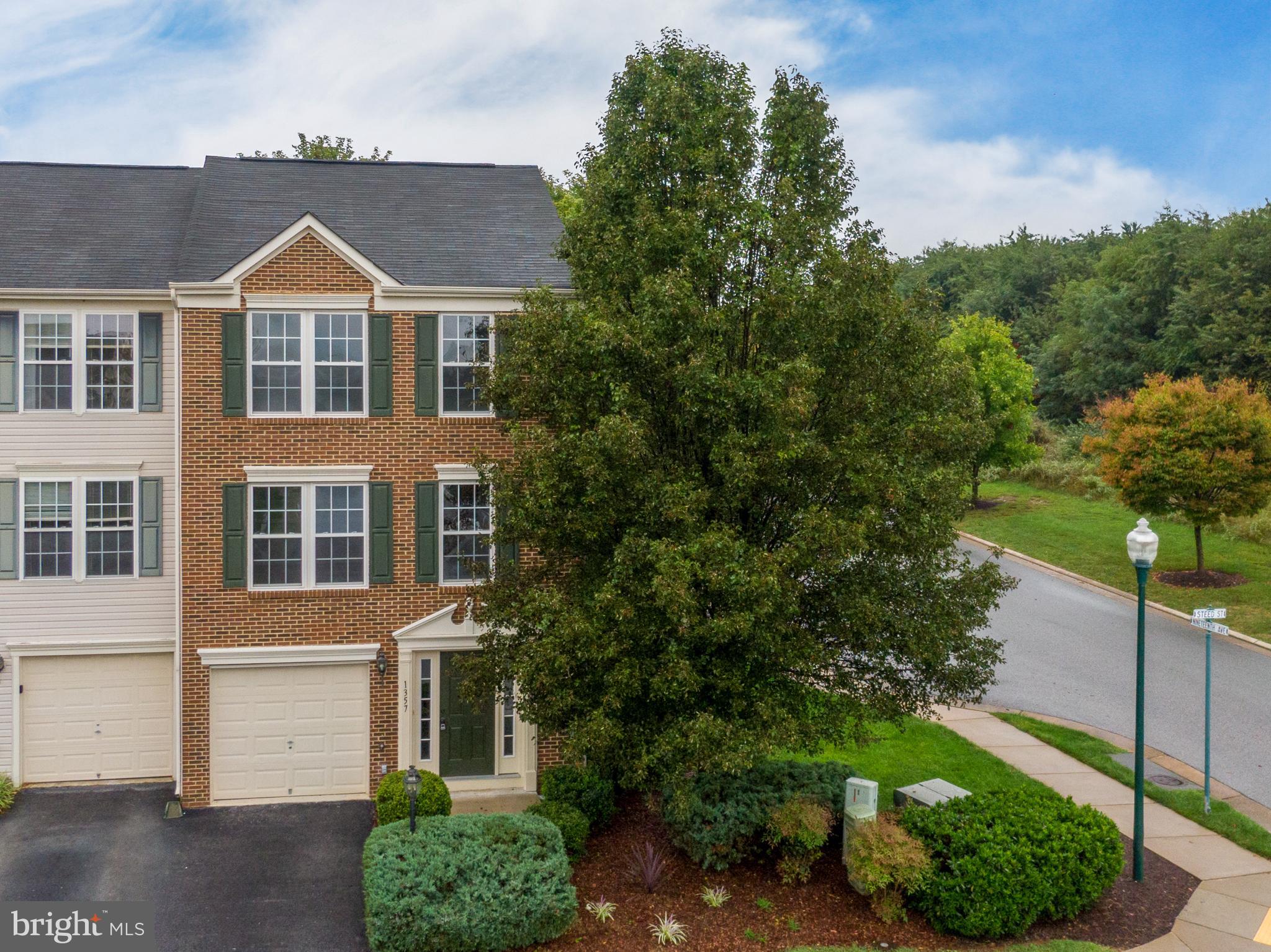 End Unit Model Home in Fairfax Crossing!  This end-unit townhome has extra windows and is light, bright, and open! New paint and flooring throughout, so it is ready for you to move right in and make it yours!  So many upgrades... living room with double chair rail and new carpet that opens to the eat-in kitchen with Corian counters, Luxury Vinyl Plank flooring, a large bump-out with electric fireplace, and access to the shaded deck.  The upper level features an owners' suite with vaulted ceilings, walk-in closets, ensuite bath with a soaking tub and dual vanities.  The basement is fully finished as well, with a family room, laundry room, and half bath, all walking out to the shaded patio.  This extra-large end-unit lot has been well maintained and has mature landscaping and a sprinkler system installed.  This is a do-not-miss-the opportunity for a home with a mountain view in a super convenient neighborhood that is located close to everything you need!