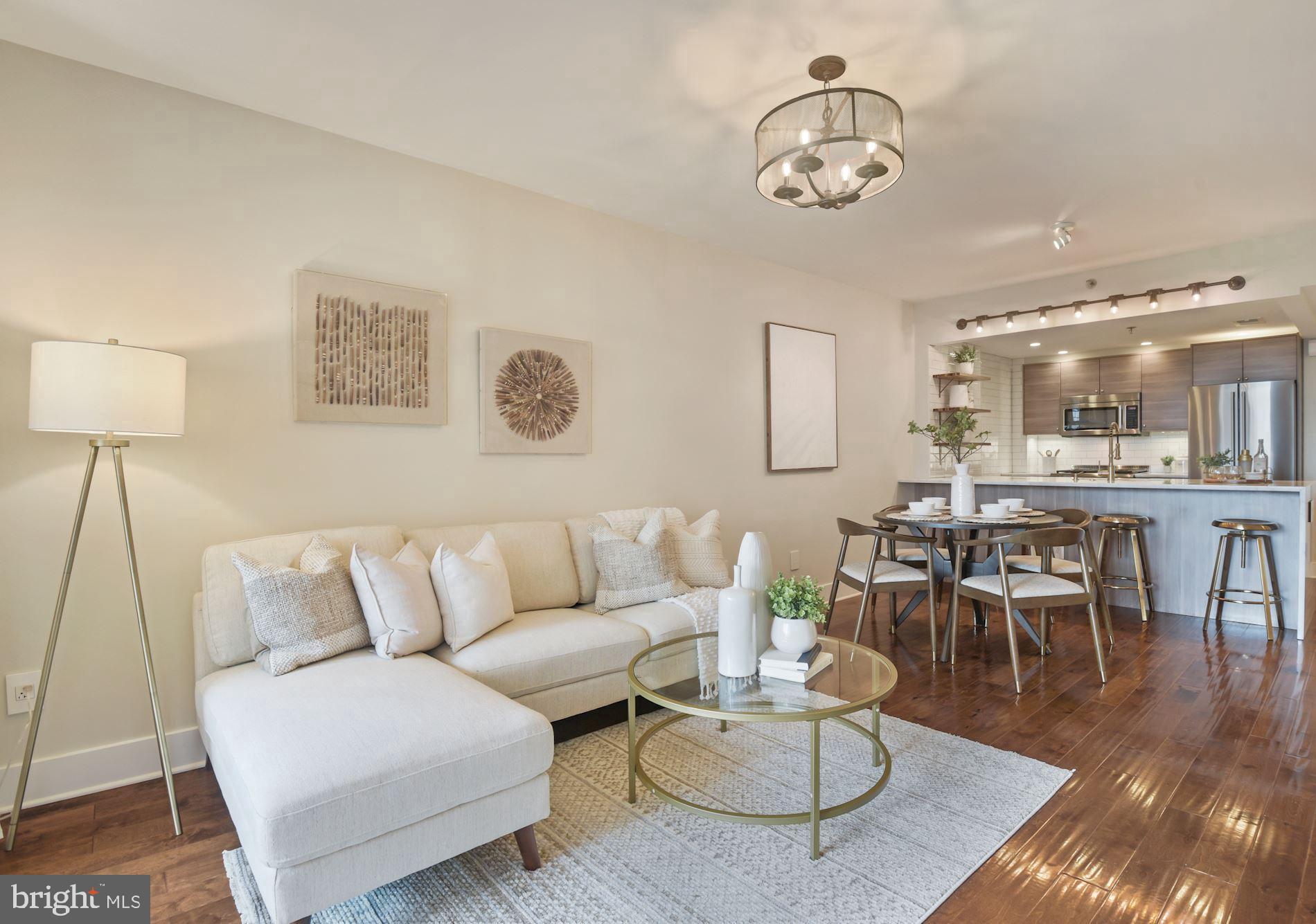 Urban living in the heart of Bethesda! Rare opportunity to own this gorgeously renovated two bedroom and two bathroom corner unit condo in the Christopher Condominium. This warm and sophisticated corner unit has been updated from top-to-bottom exemplifies prime city living. Come inside this sleek and modern unit and be wowed with the large window bringing in the natural southern exposure sunlight and sharing breathtaking views. Wide-plank maple wood floors sweep through the spacious, open floor plan of this splendid condo. The open floor plan is the perfect space for living, dining, and entertaining! Be the envy of all your guests with your modern gourmet kitchen complete with stainless steel appliances, large Carrera Marble Waterfall countertop, subway tile backsplash, and panelized dishwasher. The kitchen also features modern kitchen cabinets with soft-closing doors, drawers, a Spot Free Champagne Bronze High Arch Commercial Style Kitchen Faucet, recessed pop-up electrical outlet on counter with USB and under cabinet accent lighting. The kitchen's crisp, modern lines seamlessly flow into the bright and open dining room & spacious living room. Enjoy your morning coffee on your private deep covered balcony with breathtaking views of downtown Bethesda. Walk into the tranquil primary suite with custom closets, custom window blinds and blackout drapes and ensuite bath featuring Carrera marble double vanity with soft-closing cabinetry, glossy Subway wall with herringbone accent design, deep soaking tub with built-in seated bench, satin bronze bath fixtures and towel bars, Bluetooth fan/combo plays audio selection from mobile device, Duravit high-efficiency toilet, Italian floor tile, custom in-wall wooden shelving, oversize wall-to-wall vanity mirror, wall plate with USB and light-sensing night light. A large second bedroom perfect for relaxing & recharging or turn it into an office for those work from home days featuring custom closet, custom window blinds and blackout drapes and great southern sun exposure. The modern second bathroom features Carrera marble waterfall countertop, satin bronze bath fixtures and towel bars, frameless glass shower enclosure, glossy Subway tile with toiletry shelf, Duravit high-efficiency toilet, and mirrored medicine cabinet. This unit features NEST programmable energy saving thermostat, LED recessed lighting and design light fixtures, all new modern interior doors with Emtek door knobs throughout home, custom window wood blinds, a laundry closet with full size LG washer/dryer and custom design wall outlets with USB charging ports in every room. The unit comes with a separately deeded garage parking space (#137).  This condo building includes incredible amenities - 24/7 Concierge Service, Pet-Friendly Building, Secure Parking Garage, Outdoor Swimming Pool, Fitness Center,  Meeting Room, Party Room, Bike Racks, Secure resident storage lockers and a Grilling and Picnic Area. The Christopher is located in the hottest part of Downtown Bethesda between Bethesda Row and Woodmont Triangle hotspots. Dream location for commuters, and city goers! Walk-score 96! Located across from Bethesda Metro (red line). An impressive array of award-winning restaurants, boutiques and parks just outside your door. This impeccable condo is one not to miss!