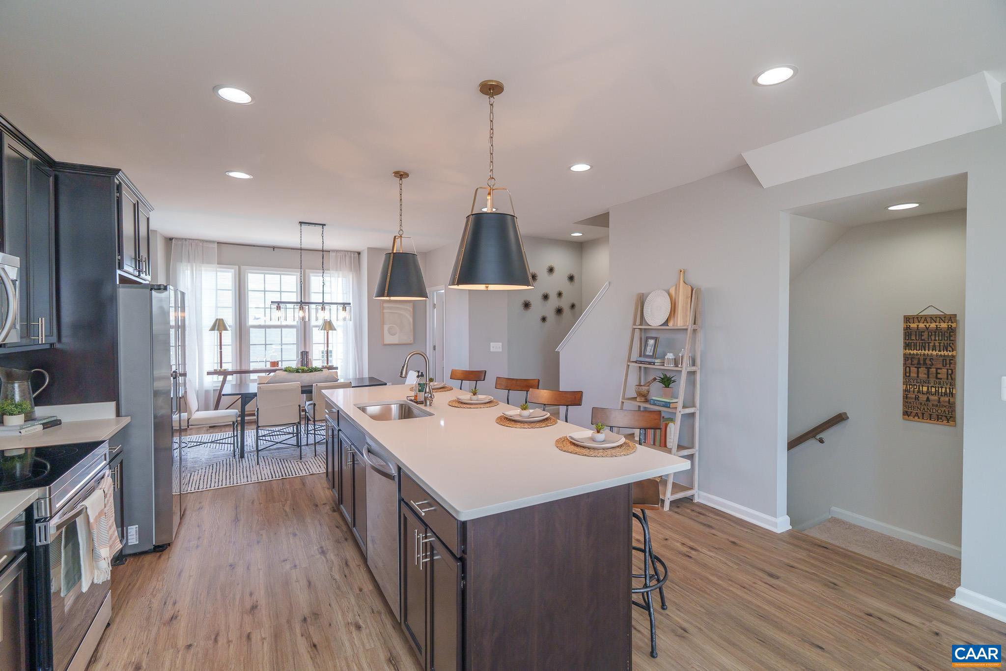 Immediate Move-in This beautifully designed 3-level townhome offers over 1,850 sq. ft. of finished living space and a 1-car garage. With 3 bedrooms, 2.5 baths, and thoughtful upgrades throughout, there?s plenty of space for everyone.  The mid-kitchen layout is perfect for entertaining, featuring a 9-foot island, 42" cabinets, granite countertops, cabinet pantry, and stainless steel appliances.  Upstairs, the owner?s suite offers a private retreat with dual vanities, a step-in shower, and a large walk-in closet. Finished bedroom and full bath on first level.  All bathrooms and the laundry room are finished with upgraded ceramic tile, while LVP flooring enhances the foyer, kitchen, family, and dining rooms. A security system is included, and the HOA provides lawn care for low-maintenance living.  Photos may contain options that are not standard on all models or not an included feature. Pictures and virtual tour are of a model home and show optional upgrades  Ask about current incentives available with use of our preferred lender and title company!,Granite Counter,Maple Cabinets