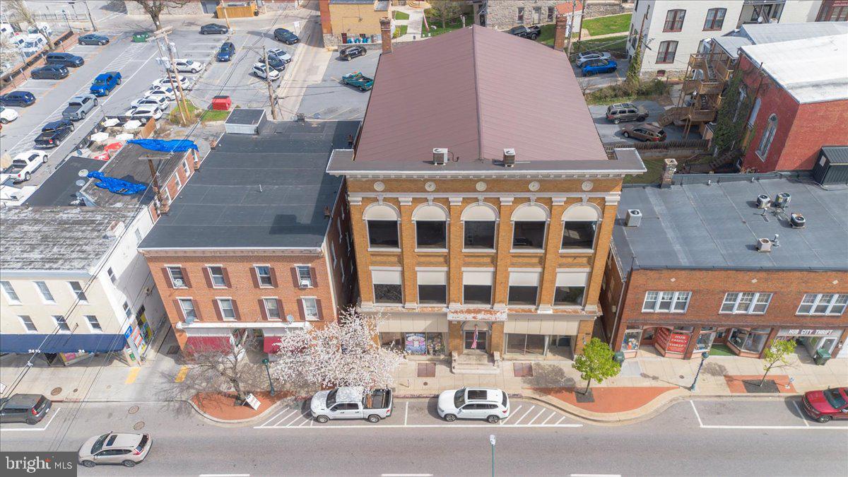 Historically Significant Piece of Hagerstown's History - Landmark Renaissance Revival Building, three-stories of brick & stone construction, monumental pilasters spanning two-stories, ornate modillioned cornice with dentil & decorative corner pendants. Listed on National Register of Historic Places. Circa 1907 this building was dedicated in 1908 by Knights of Pythias as a gathering place dedicated to "friendship, charity & benevolence."  The third floor ceremonial hall is early venue where Patsy Cline's musical career began in 1952, transforming her from local talent to a superstar of American Music.  This 12,790 sq ft building has a clean open canvas, ready for adaptive re-use by the next developer, investor or visionary.   Stunning architectural details, original staircase, wood floors, millwork and high ceilings, metal roof approximately 10 years old...imagine the possibilities!    In short, it’s not just a redevelopment site—it’s a piece of Hagerstown’s cultural and architectural legacy with built-in storytelling value, especially for music history and early 20th-century fraternal life.    Today the property is Center City Mixed Use Zoning offers blend of commercial, residential, offices, shops, event space, boutique/hospitality, live/work environment, etc.   High visibility, foot traffic and proximity to local amenities, government offices & cultural attractions.   Don't miss this blank slate re-development opportunity in one of Maryland's most historic downtowns.