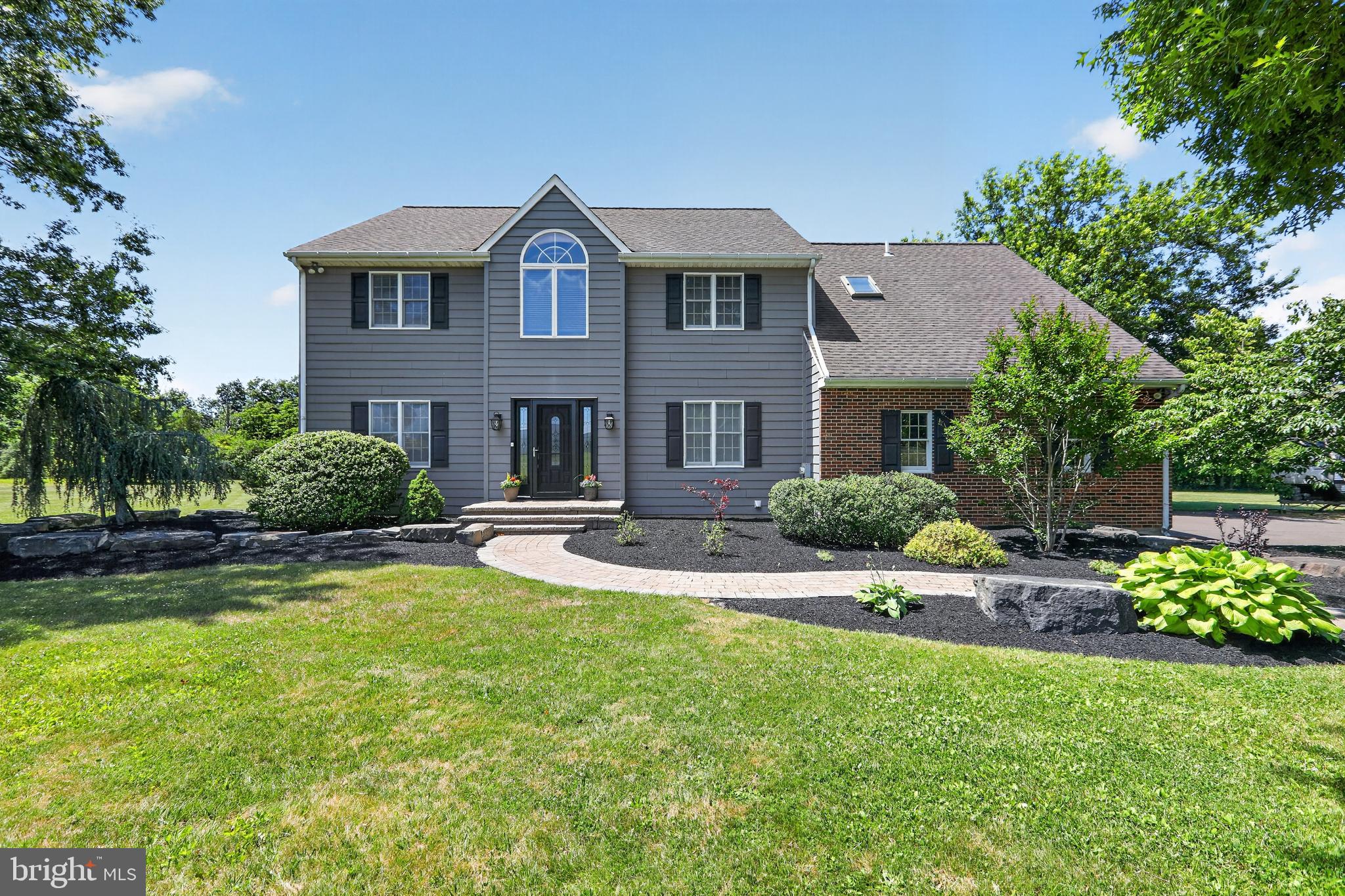 Welcome to 2002 Broad Street, an over 3,000 sq/ft Colonial situated on 3.5 picturesque acres in scenic Hilltown Township. Guests are greeted by stately paver entry steps leading to a two-story foyer that sets an elegant tone for this special home. Hickory hardwood flooring spans nearly the entire main level, which features a well-appointed home office with double doors, a large light-filled living room, and a sizeable dining room perfect for gatherings.  The kitchen boasts an abundance of cabinetry, granite countertops, new refrigerator, center island, custom tile backsplash, and a breakfast area, seamlessly flowing into an impressive family room enhanced by a floor-to-ceiling wood and brick fireplace surround, vaulted ceilings, dual skylights and new carpet. A powder room and laundry room (with new washer) are located on the main level, as well. This home features both a front and rear staircase, providing two convenient paths to the second floor. Upstairs, an expansive primary bedroom suite offers two walk-in closets and a renovated bath with a standalone tub, stall shower, custom tile, and double vanity. Three additional secondary bedrooms—one with a convenient landing connecting it to the primary suite—and an updated hall bathroom with a large skylight complete this level. The entire second floor has brand new carpeting and new light fixtures have been installed in the spacious hallway. Outside, the sprawling acreage is suited for a range of outdoor activities, and the multi-level composite deck is perfect for entertaining friends or soaking in the privacy and serenity of the rear grounds with a cup of coffee. With a two-car attached garage plus an additional two-car detached garage, a full poured concrete basement offering excellent storage or expansion potential, 2 x 6 construction, architectural shingles, and a one-year home warranty included, this home is truly move-in ready. Ideally located less than a mile from Peace Valley Park/Lake Galena, Tabora Farm & Orchard, and Bishop Estates Winery, this home also offers quick access to the vibrant shops and restaurants of the Dublin Town Center and is just 15 minutes to the center of Doylestown Borough. Book your showing today!