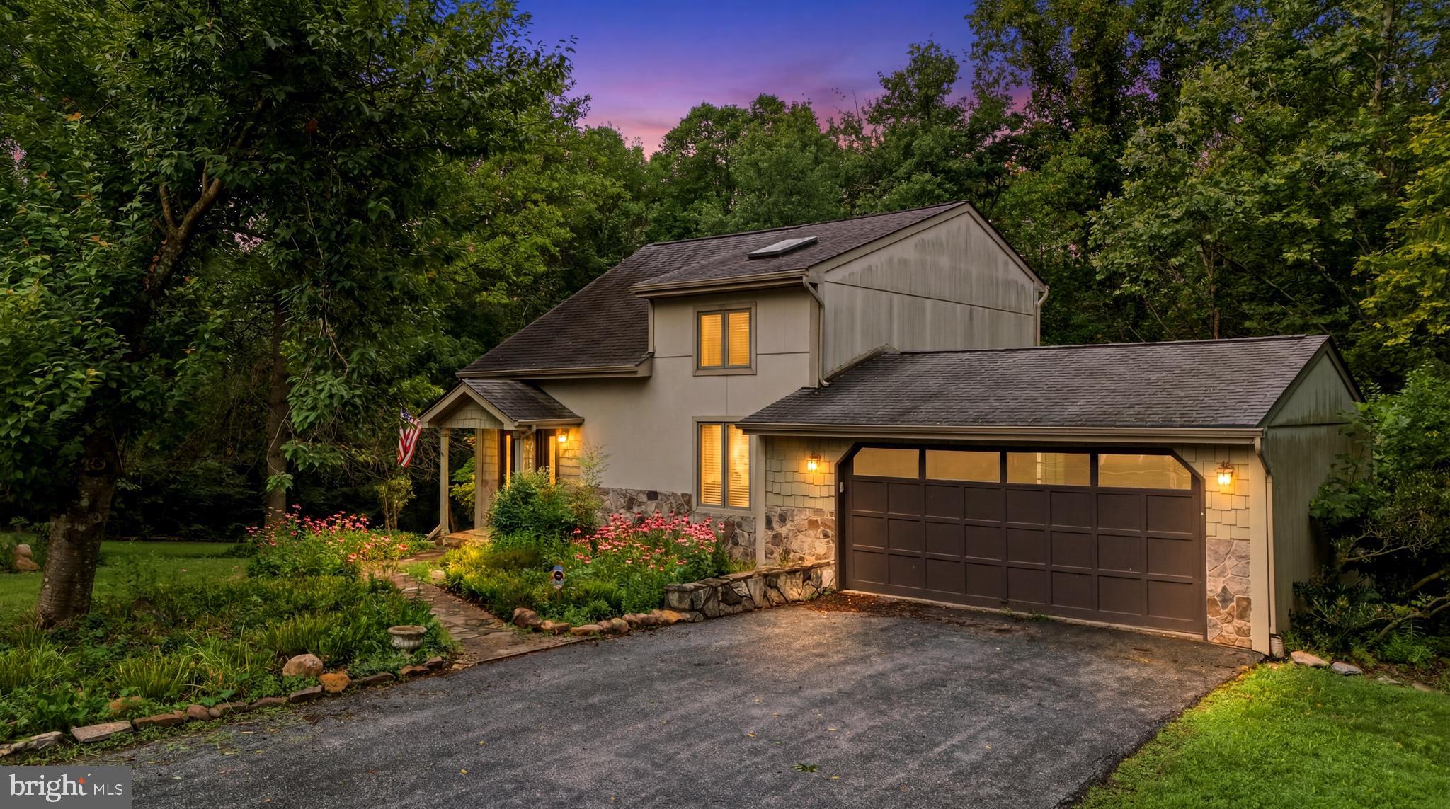 Located in the desirable Woodbrier Golf Course community, this charming contemporary home offers the perfect blend of comfort, character, and privacy. Nestled on a beautifully treed lot, the property features expansive decks for outdoor entertaining and a restored outbuilding that's ideal for gardening, potting, or additional storage. 
Inside, soaring ceilings and an open floor plan create a bright, airy feel. The main level is finished with beautiful hardwood flooring, while the bathrooms feature durable ceramic tile. Custom built-ins and gas fireplace with a mantle, add both style and functionality throughout the great room, main-level bedroom, and kitchen, which also features a cozy breakfast nook.  The second-floor loft overlooks the great room and offers flexible space that could easily serve as a fourth bedroom, home office, or hobby room. The lower level includes a finished bedroom plus an unfinished area with walk-out access to the backyard, providing excellent potential for additional living space, a recreation room, or workshop.  Rough In plumbing for half bath in lower level as well. This inviting home offers a peaceful setting with plenty of room to grow.