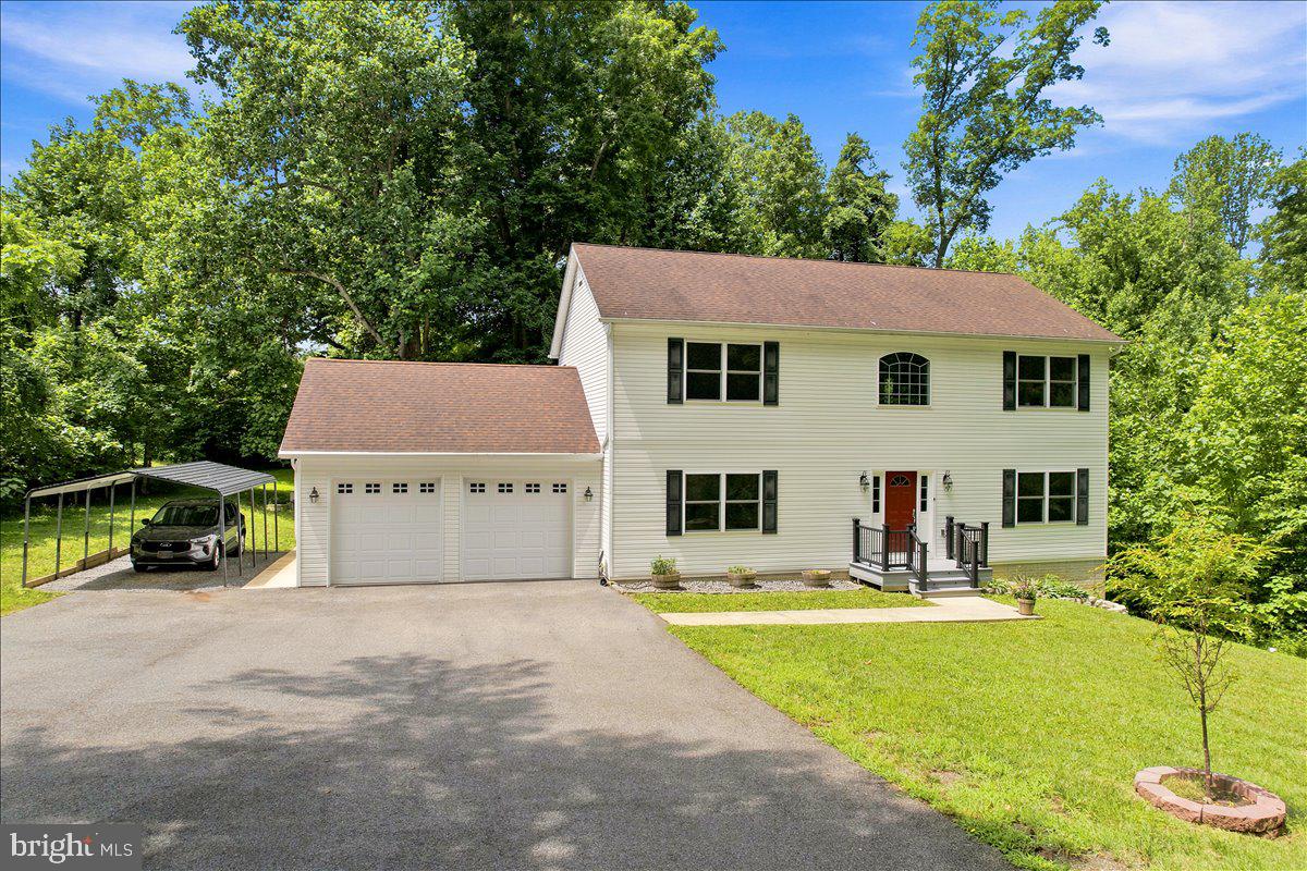 Looking for the perfect blend of privacy and accessibility? This low maintenance Colonial-style home, nestled on a generous 2.49-acre lot offers just that! No HOA!! A private paved driveway and surrounding hardwood trees provide privacy and a quick drive to Route 4 provides the convenience.  Built in 2016, this 4 BR/ 2.5 BA residence features 2,464 square feet of  living space plus an unfinished basement for storage and future improvements. The kitchen has been upgraded to include app-controlled LG Thin-Q appliances and granite counters, connected to a spacious family room with modern electric fireplace. It is a great entertaining flow! The lot is very private, and from the newer rear deck you will enjoy the hardwood trees and changing seasonal colors, also many varieties of birds.  The parking area is plentiful,  with a front-entry attached two car garage and a detached carport that is equipped with two 240v EV-ready NEMA 14-50 outlets. This home is more than just a property; it's a sanctuary where you can create memories that last forever. Chesapeake Beach town center with stores and restaurants is close by, and Prince Frederick is a 10 minute drive for more shopping and services. The lot has a Forest Retention Area (FRA) and a natural path for hikes and discovery! See boundary line survey notes for details.