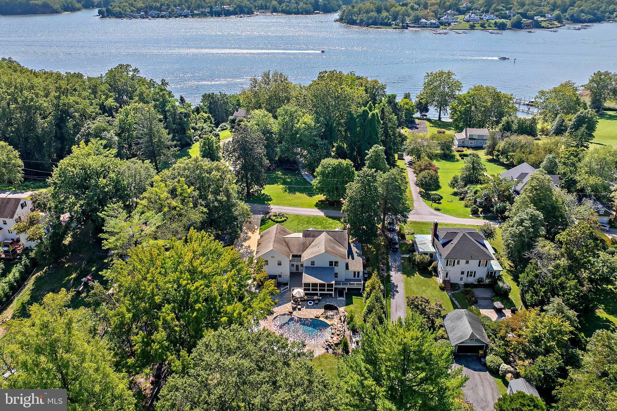 Welcome to this timeless four-bedroom residence, tucked away on one of the most beautiful waterfront lanes in Anne Arundel County. Set on 2.3 acres framed by mature trees, this property offers privacy, serenity, and an unmatched sense of place. 
The backyard is a true oasis featuring a sparkling saltwater pool, outdoor shower, koi pond and expansive entertaining areas—perfect for summer gatherings or quiet evenings at home. Across the street, an additional deeded 0.06-acre lot provides 15 feet of waterfront on The Severn River with a pier storage unit and seating area, offering a front-row seat to the Chesapeake lifestyle.
Classic in design and surrounded by top-rated schools, this home blends charm, comfort, and outdoor living in one of the county’s most sought-after locations.  Severna Park Schools, A true Chesapeake retreat!