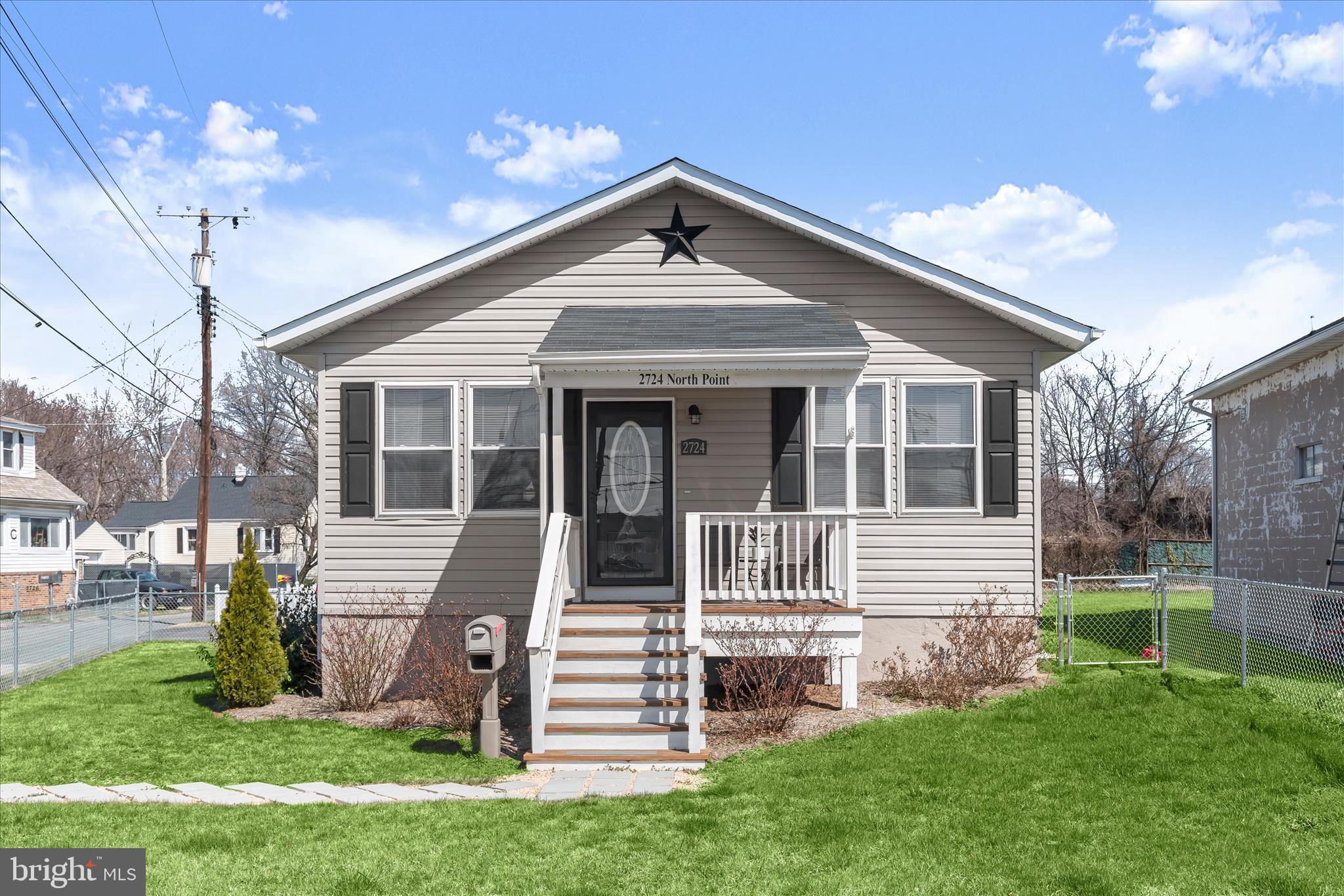 Pristine and recently updated, this 2-bedroom, 1-bath home in North Point Terrace offers comfort, convenience, and easy single-level living. A welcoming covered front porch leads inside to a sunny open floor plan featuring laminate plank flooring and a pleasing neutral color palette throughout the main living areas. The living room flows seamlessly into the dining area and kitchen, where granite countertops, stainless steel appliances, and a double sink create a functional and attractive space for everyday living. A side entrance from the kitchen provides easy access to the extended driveway and a roll-up door outbuilding that can accommodate a vehicle or serve as additional storage or workshop space. Two comfortable bedrooms feature wood-inspired laminate plank flooring and ceiling fans, while the full hall bath includes ceramic tile flooring and a tub/shower with decorative tile surround. Main level laundry adds to the ease of one-level living, and the full unfinished basement offers excellent storage for seasonal items, sports equipment, and more. Move-in ready and conveniently located with easy access to I-95 and I-695, this single-family home is a wonderful opportunity.