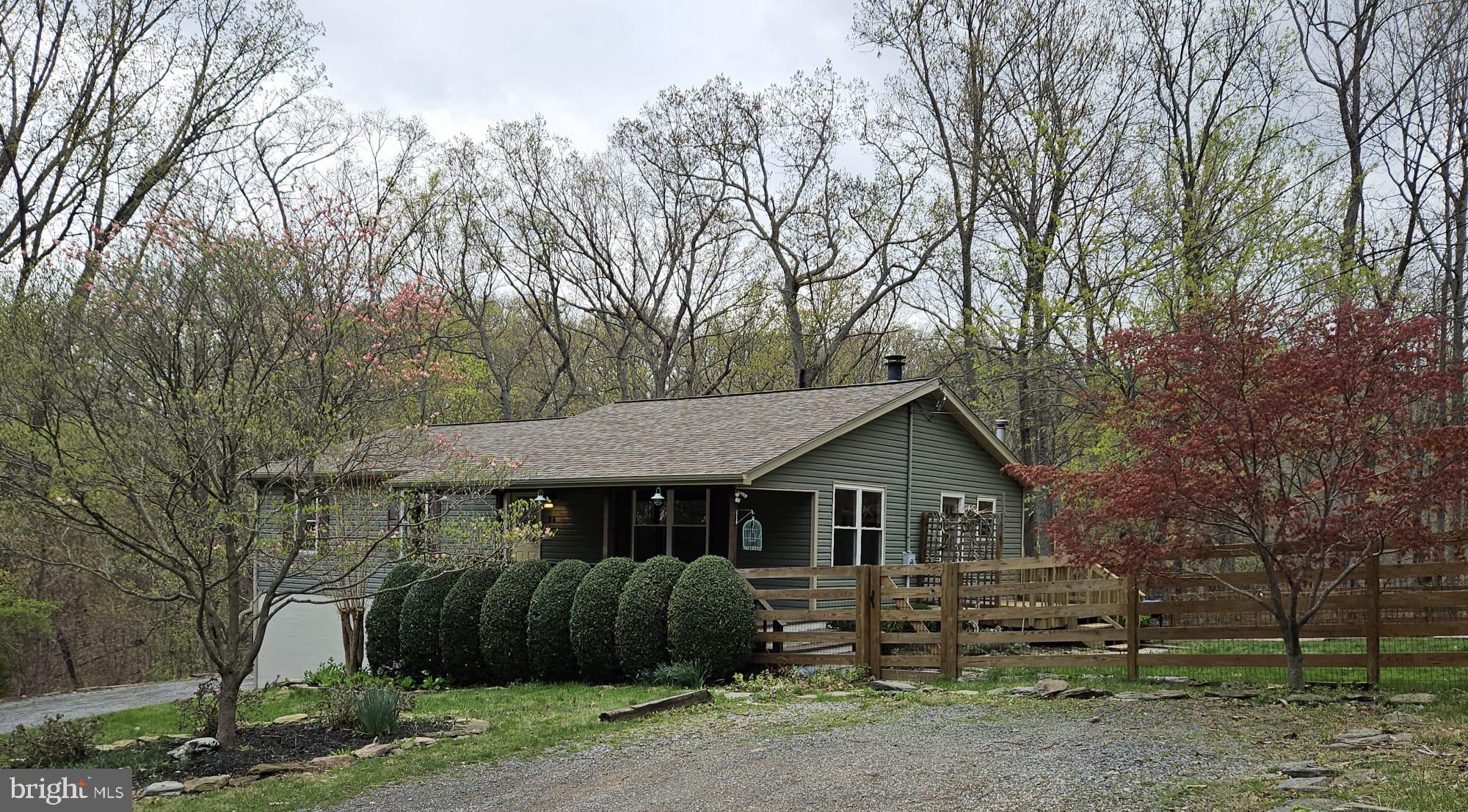 Welcome to this beautiful 3-bedroom, 3-bath rancher nestled in the peaceful Shannondale community of Harpers Ferry—just minutes from the Virginia line and only 25 minutes west of Leesburg, VA.
This spacious home features gleaming hardwood floors throughout the main living areas, with stylish tile flooring in the kitchen and bathrooms. Enjoy cozy evenings by the stunning stone fireplace in the living room or take in the serene surroundings from the inviting front and back porches.
Downstairs, you'll find a large walkout fully furnished basement offering endless possibilities—perfect for a future finished living area, recreation room, home gym, or additional storage. With easy access to the backyard and garage, it adds valuable flexibility and potential to the home.

Situated on a generous 0.58-acre lot, the property boasts a fully fenced yard—ideal for pets, play, or gardening. An attached 2-car garage completes the package.

Located in a quiet, wooded setting, this home offers the perfect balance of privacy and convenience. Don’t miss your chance to own a little piece of West Virginia paradise!