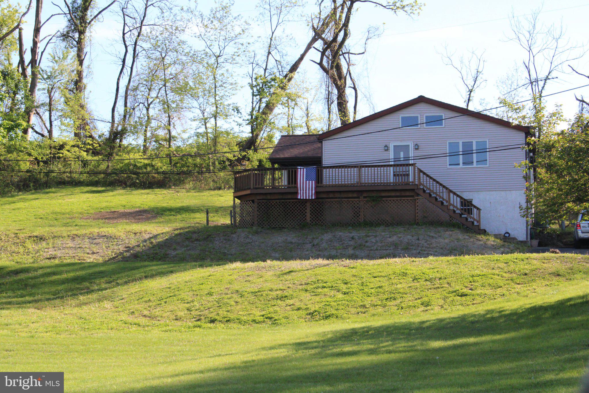 Affordable and charming, this Boyertown Schools bungalow sits on a picturesque 2‑acre stretch of countryside—your own peaceful retreat with room to breathe. A wrap‑around deck and covered, tile‑finished patio create the perfect outdoor spaces to relax, entertain, and enjoy the views. The exterior is low‑maintenance vinyl siding, and the oversized one‑car garage provides excellent storage and workspace.   There is a expanded driveway, and it is shared with one residence above the house.    Inside, the home welcomes you with a spacious living room featuring a cathedral ceiling, exposed beams, and a cozy propane stove—a warm, rustic focal point. The large eat‑in kitchen offers beautiful cherry cabinetry, a double sink, refrigerator, and propane cooking, giving you both charm and functionality.
The generously sized bathroom includes a jetted tub/shower combo and plenty of storage. Both bedrooms are surprisingly roomy, offering comfortable layouts and flexibility.    The basement is ready for your finishing ideas and includes the laundry area with washer and dryer. Mechanical updates include a newer heater, newer oil tank, and central air for comfort in the warmer months.  This is a wonderful opportunity to make a cozy home on a beautiful country two acre parcel truly your own!