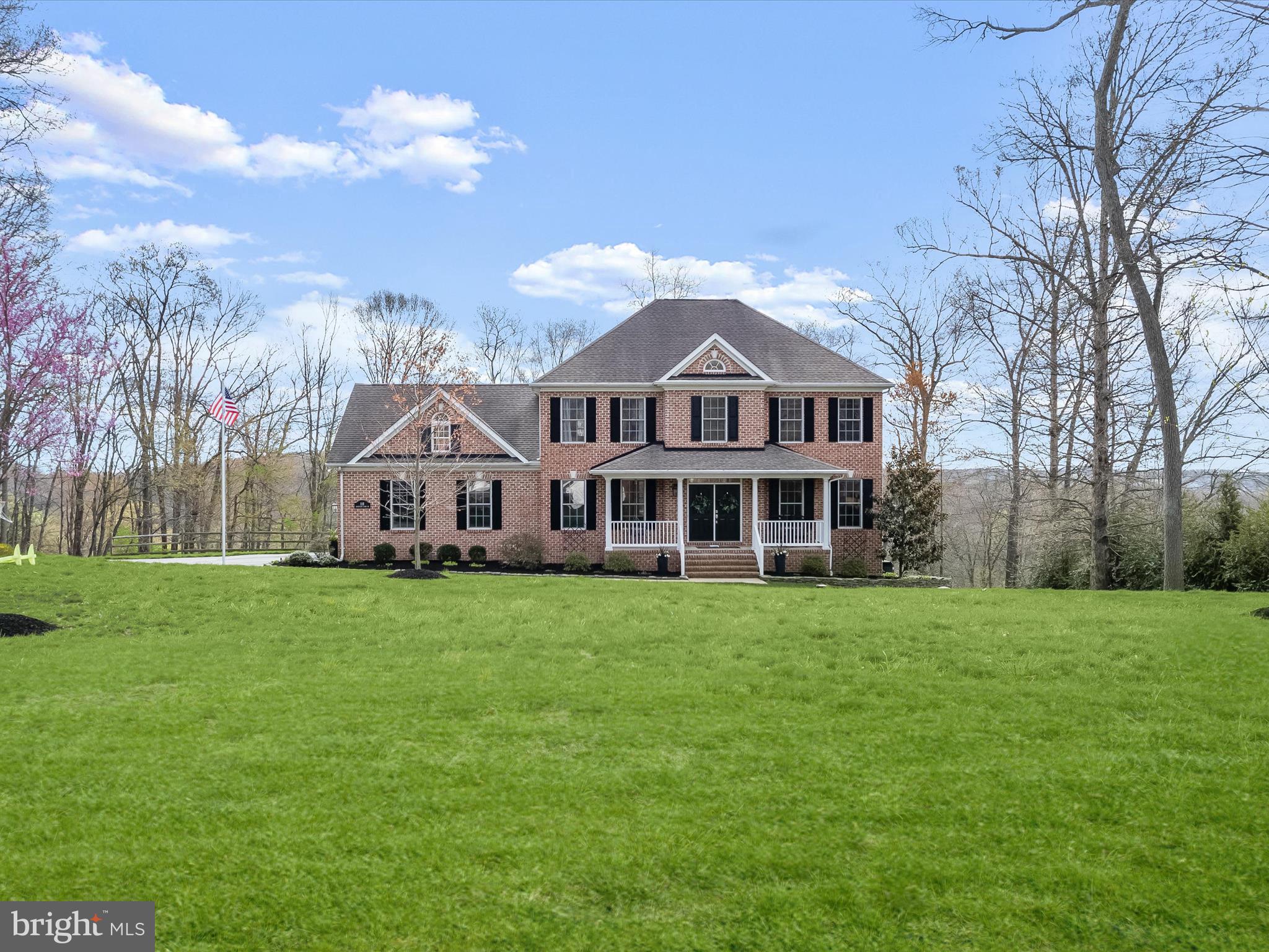 Welcome to 118 Graystone Farm Road, a distinguished custom-built residence nestled in the serene Graystone Farms Estates of White Hall, Maryland. This 4-bedroom, 4.5-bathroom home spans 4,604 square feet and sits on a picturesque 1.41-acre lot, offering both luxury and tranquility. 
From the moment you arrive, the thoughtfully landscaped, lush grounds make a striking first impression. A charming covered front porch leads you into a grand foyer, gracefully framed by arched entryways that open to a formal dining room and a versatile living room, ideal as an executive-style office. Elegant custom millwork, including built-ins, crown molding, chair railing, and box wainscoting, paired with rich hardwood floors and a serene neutral palette, establish a tone of timeless luxury throughout. This beautifully remodeled home showcases extensive upgrades, including high-end appliances and custom cabinetry. At the heart of the home lies the gourmet, eat-in kitchen — a chef’s dream with its expansive 8 ft center island, stainless steel appliances including a Bosch dishwasher, custom 42”inch; cabinetry, and gleaming granite countertops. The sunny breakfast nook, with a bay window and built-in bench seating, invites peaceful morning moments bathed in natural light. Just beyond, the inviting family room features plush carpeting, a wood accent wall, and a cozy gas fireplace set within a handsome brick surround, offering a perfect gathering space. Step through to the screened porch and composite deck, where breathtaking views and a sunken hot tub promise hours of relaxation and restorative indulgence. An entry mudroom with direct access to the upgraded, oversized 2.5-car garage — complete with epoxy flooring, built-in shelving, and ample storage — ensures both organization and ease. A refined powder room completes this exceptional main level. Ascend to the upper level, where the luxurious updated primary suite awaits with a tray ceiling, walk-in closet, and a spa-inspired en suite bath featuring a frameless, ceramic tile surround soaking tub, dual showerheads, and a handheld spa shower for a truly indulgent retreat. Three additional spacious bedrooms — including one with a private en Suite bath — a well-appointed hall bath, and a convenient upper-level laundry room complete this floor of elevated living. The lower level is an entertainer's dream, offering a sprawling recreation room with a custom wet bar, a private home gym for staying active year-round, and a walk-out to an extraordinary backyard oasis. The rear yard offers many entertaining possibilities  including your own campsite area complete firepit to enjoy. There is a thoughtfully designed play area to create a space that’s equally suited for lively gatherings or quiet evenings under the stars. Located within the esteemed Hereford School Zone,this home combines refined living with the peace of a countryside setting. Its proximity to 83, Hunt Valley, the NCR Trail, and the Gunpowder River provides ample opportunities for recreation and convenience. Custom-crafted with impeccable attention to detail, this stunning residence promises to exceed the expectations of even the most discerning Homeowner.  Home features high quality Anderson windows and doors.
Recent mechanical updates include (2) HVAC systems (2020), two water heaters (2021),whole house water filter and neutralizer tank (2018), new well pressure tank and well pump (2024), Water softener added  (2022)