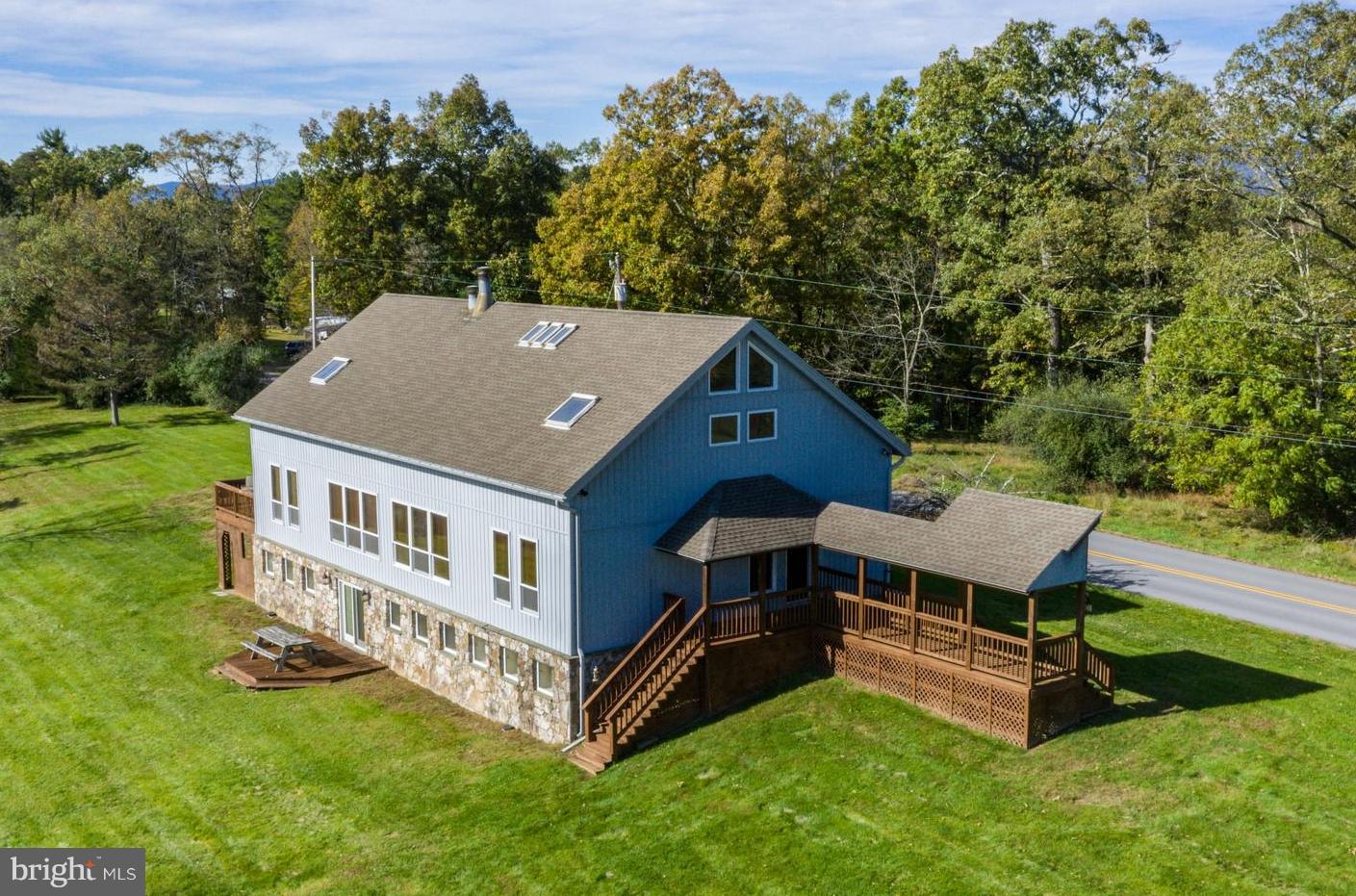 Well appointed converted post and beam barn is truly a one of a kind property.  Located on 2.79 acres with scenic views. What you see is what you get...this fabulous property is being sold fully furnished! Ideal venue to corporate functions, hunting club, weekend getaway or quiet primary residence.  Main level, 2 story, open floor plan offers random width oak floors, beamed ceilings, living room with a stone wood burning fireplace, grand dining area, breakfast area, full service bar for entertaining, kitchen and adjoining prep kitchen with convenient laundry closet. Spiral staircase to open 2nd floor catwalk has two bedrooms each with private full baths. Spiral staircase to lower level has a spacious family room with stone wood burning fireplace, 2 bedrooms, full bath and den/office that could also be converted to a 5th bedroom. New heat pumps in 2014, well holding tank in 2015, roof and siding in 2007.  Property is 45 mins from I-81.  4608