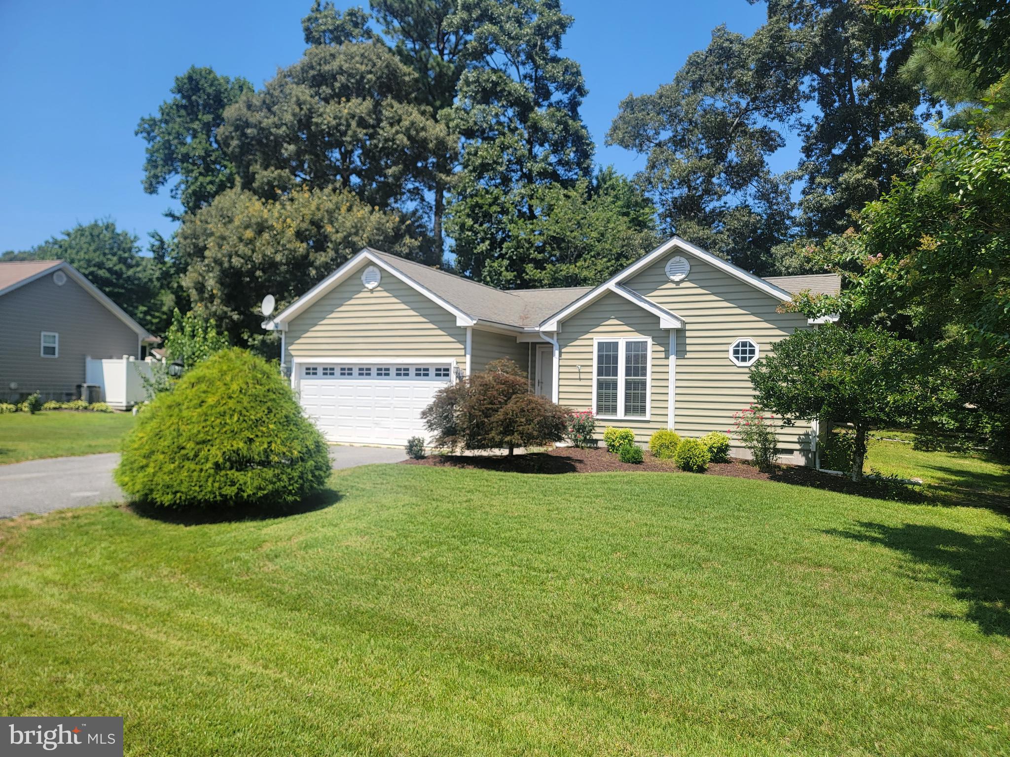 This lovely 3 bedroom, 2 bath home with split floorplan is situated in the Oak Crest Farm neighborhood in Lewes.  You will enjoy the large open concept living space with cathedral ceiling and well equipped kitchen with  peninsula and plenty of counter space for family get togethers.  The kitchen has granite countertops and updated stainless steel appliances.  Directly off of the great room is a large 3 season sunroom/porch with propane fireplace to keep you cozy in the colder months.  The owners suite is situated in the front of the home with a private bath and walk in closet.  The 2 other bedrooms are located separately for privacy and include a full hall bath.  The heat pump with Propane back-up  and A/C were replaced recently as well as the hot water heater just a few years ago.  Kitchen appliances were also replaced in recent years.  Freshly painted walls will welcome into this cozy house with wooded rear and side yard.  This quiet community boasts an outdoor pool and clubhouse with a  peaceful setting for those lazy summer days.  Low HOA fees and a short drive to area beaches and restaurants make this the perfect home or beach retreat.  Don't hesitate, this one won't last long!!