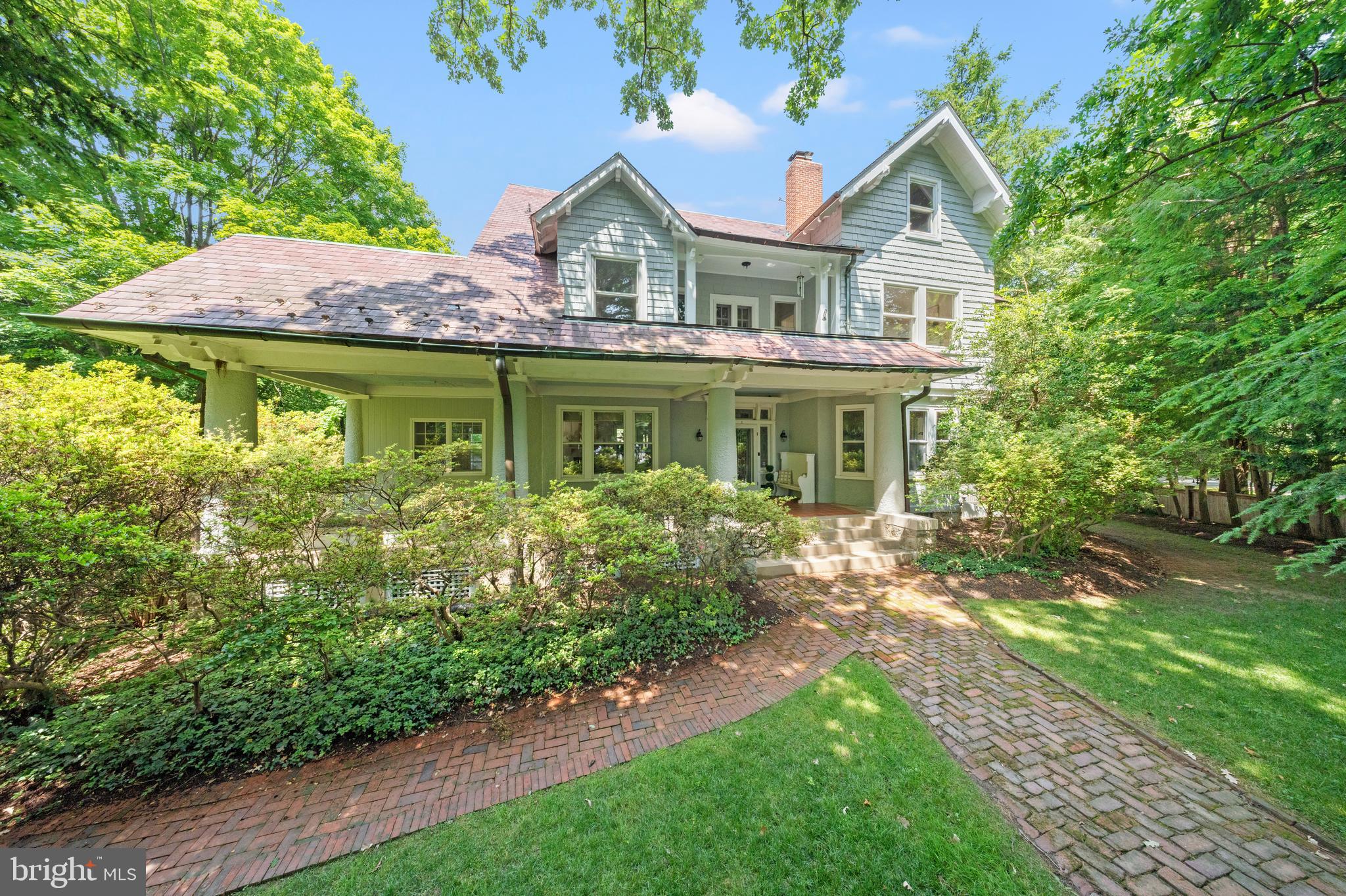 Exterior painting has just been completed, and this Grand Dame now stands resplendent in Benjamin Moore's historic Coventry Gray. The timeless hue enhances the home's architectural grandeur and commanding presence while honoring the enduring elegance that has made 5 Chevy Chase Circle one of the village's most recognizable and admired residences.

Positioned prominently on the Circle, a gracious front porch sets the tone, leading to an elegant entryway with a welcoming vestibule that reflects the home's comfortable yet sophisticated character. This substantial residence of approximately 7,000 square feet includes seven bedrooms, five full baths, and a powder room.
The main level offers a beautifully flowing floor plan ideal for both everyday living and entertaining. A spacious entry hall provides access to multiple patios overlooking the pool, seamlessly connecting indoor and outdoor spaces. The grand yet inviting living room accommodates multiple seating areas and is complemented by a wood-paneled study. A formal dining room with butler's pantry creates a refined setting for gatherings, while a mudroom off the kitchen adds everyday convenience.

The spacious eat-in kitchen features a classic Aga stove, Sub-Zero refrigerator, two Bosch dishwashers, counter seating, a dedicated dining area, striking pendant lighting, Farrow & Ball wallpaper, and an adjoining butler's pantry. A light-filled sunroom with three exposures overlooks the pool and provides additional patio access. Thoughtful details, including window seats and banquette seating, add warmth and character throughout.

The primary suite features a fireplace, dressing area, cedar walk-in closet, and ensuite bath with dual sinks. An additional ensuite bedroom, two secondary bedrooms, and a hall bath complete the second level. The third floor offers a spacious living area with built-in bookcases, three additional bedrooms, and a full bath. Generous landings, a back staircase, and flexible spaces throughout provide exceptional versatility.
Outside, a private pool surrounded by brick patios is complemented by secluded garden spaces, mature landscaping, and brick pathways. The approximately 14,904-square-foot lot offers both privacy and beauty. A detached two-car garage, equipped for EV charging, is filled with natural light, while the lower level includes a sauna and ample storage.

Residents of Chevy Chase Village enjoy exceptional services and community amenities, including house checks, key-holding services, package collection, and village events. The home is just moments from Connecticut Avenue's shops and restaurants, Friendship Heights Metro, and Wisconsin Place.
A local landmark and testament to enduring design, 5 Chevy Chase Circle presents a rare opportunity to own one of the village's most distinguished residences in an exceptional location.
