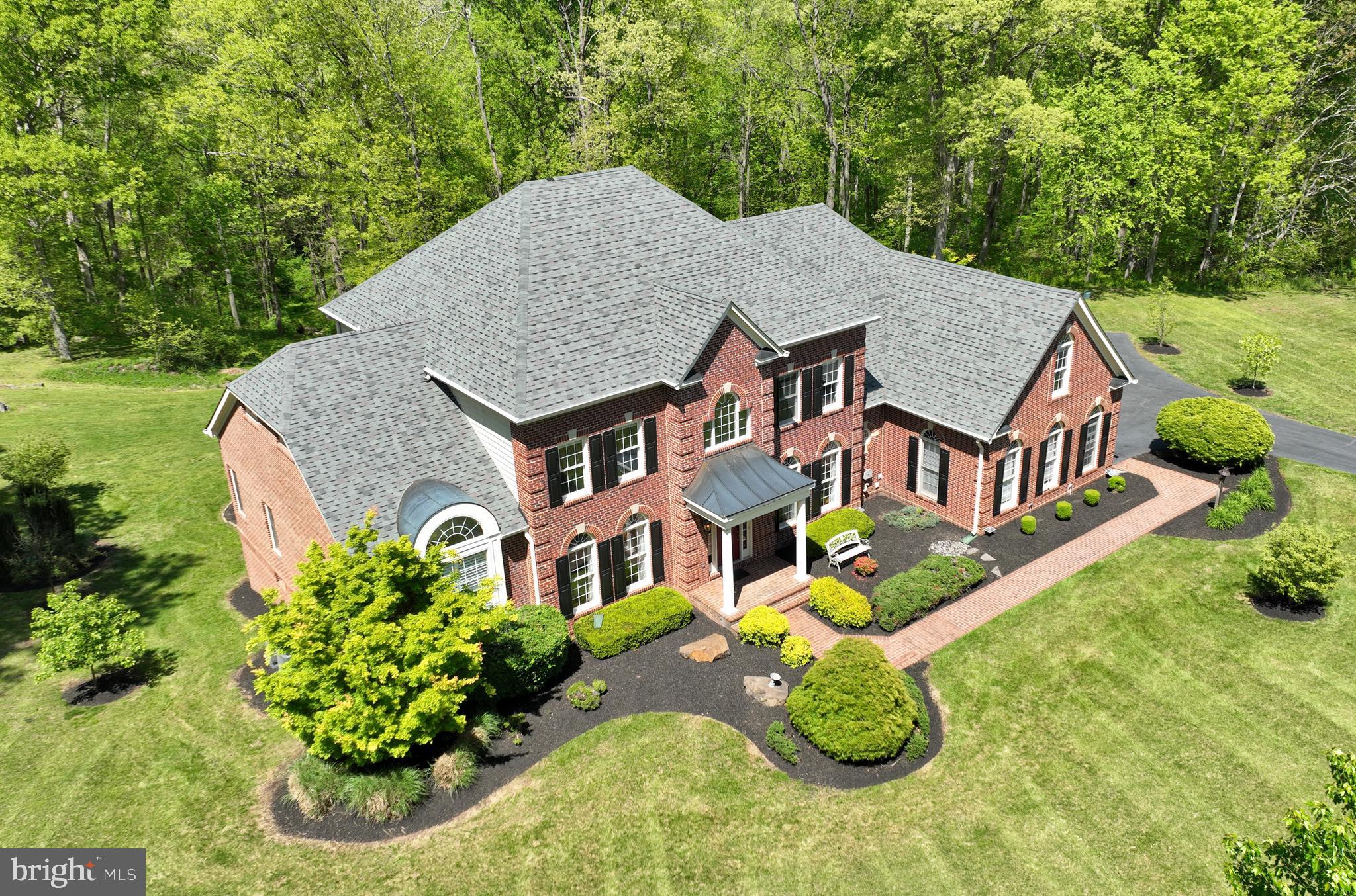 This stunning home is perfect for those looking for a secluded place to live on over 10 acres of private land in Gainesville's quiet and gated neighborhood. Boasting almost 8,000+ SF of space and a complete basement with lots of useful area, this home features 5 bedrooms along with 5 full bathrooms and 2, half-bathrooms. A grand foyer greets you as you walk in, with the main stairway directly in front and open space for a dining table to the right and a small living area to the left. Behind the main stairway is the spacious living room with vaulted ceilings and an expansive kitchen. Also on the main floor is the main bedroom with the laundry room. On the upper level, there are three bedrooms and an open space for an open office. In addition, there is available space for a potential game room, a separate bedroom, and a full bathroom in the basement. Outside, the patio with a fire pit, or the large deck, is perfect for any gatherings, and farther out, there is a barn with a bonus space.