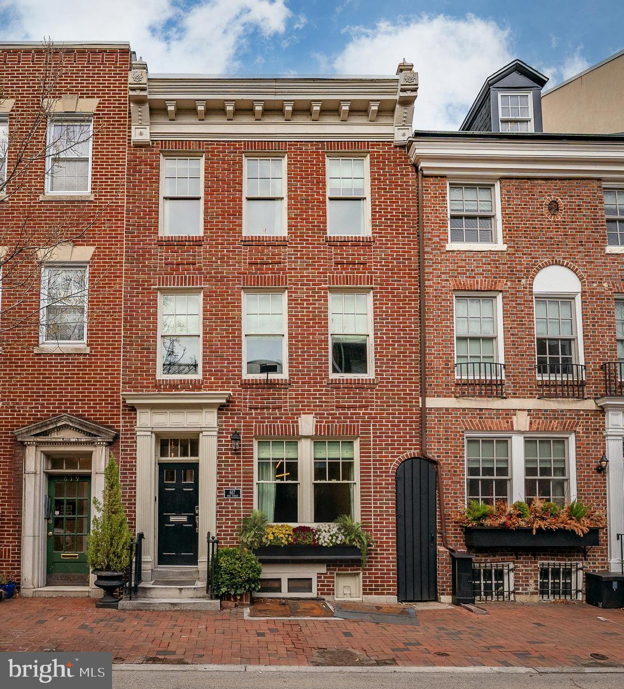 Situated in the heart of Society Hill, this distinguished three-story townhouse embodies refined urban living, seamlessly blending historic charm with contemporary luxury. With two-car garage parking, this residence offers a rare combination of space, style, and convenience
Step inside to high ceilings, recessed lighting, and rich Brazilian cherry wood floors that set a welcoming tone. The expansive living room flows seamlessly into a versatile dining or family area, where elegant architectural details enhance the home’s timeless appeal.
The kitchen is designed for both everyday living and entertaining, featuring top-tier Viking appliances, including a four-burner stove with a built-in grill. Just beyond, a private patio leads to the detached two-car garage—a true luxury in this sought-after neighborhood.
The second level is dedicated to the primary suite, filled with natural light. A wide hallway opens to an office, second level family room or extension to the already expansive primary suite.  French doors from this space lead to a newly rebuilt private deck, an ideal spot for morning coffee or evening gatherings. This floor also features a well-appointed laundry room with a sink and mini fridge, a discreet powder room, and a spacious bedroom with dual walk-in closets. The ensuite bath offers a spa-like retreat with a double vanity, oversized glass-enclosed shower, and elegant porcelain tile flooring.
The third level features three well-proportioned bedrooms and two full baths, offering flexibility for family, guests, or work-from-home needs. One bedroom enjoys the privacy of an ensuite bath, while another is enhanced by a charming (non-working) fireplace, creating a cozy atmosphere for a study or retreat. The third bedroom is spacious and bright, featuring double closets and sweeping southern views.
A fully finished lower level provides additional living space, abundant storage, and endless possibilities. A built-in surround sound system is wired throughout the home, ready to enhance any setting.
Perfectly positioned across from General George A. McCall School and just a short stroll to Washington Square and Pennsylvania Hospital, this exceptional residence offers the best of Society Hill living.

Some photos are virtually staged