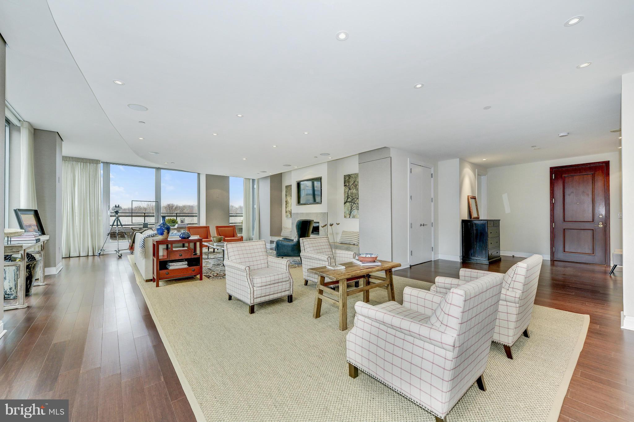 INCREDIBLE PRICE IMPROVEMENT from last time on the market! Just listed! Sun-drenched open plan w/ nearly 4000 SF boasting walls of windows, gleaming HW & incred upgrades. Balcony w/ views of river & Rosslyn skyline + priv Mstr balc. Gorgeous gourmet Kitch w/ SS appl, double LR w/ FP, Mstr Ste w/ WI dressing rm & closet, marble BA. 3 addtl BR stes. 2-car pkg.