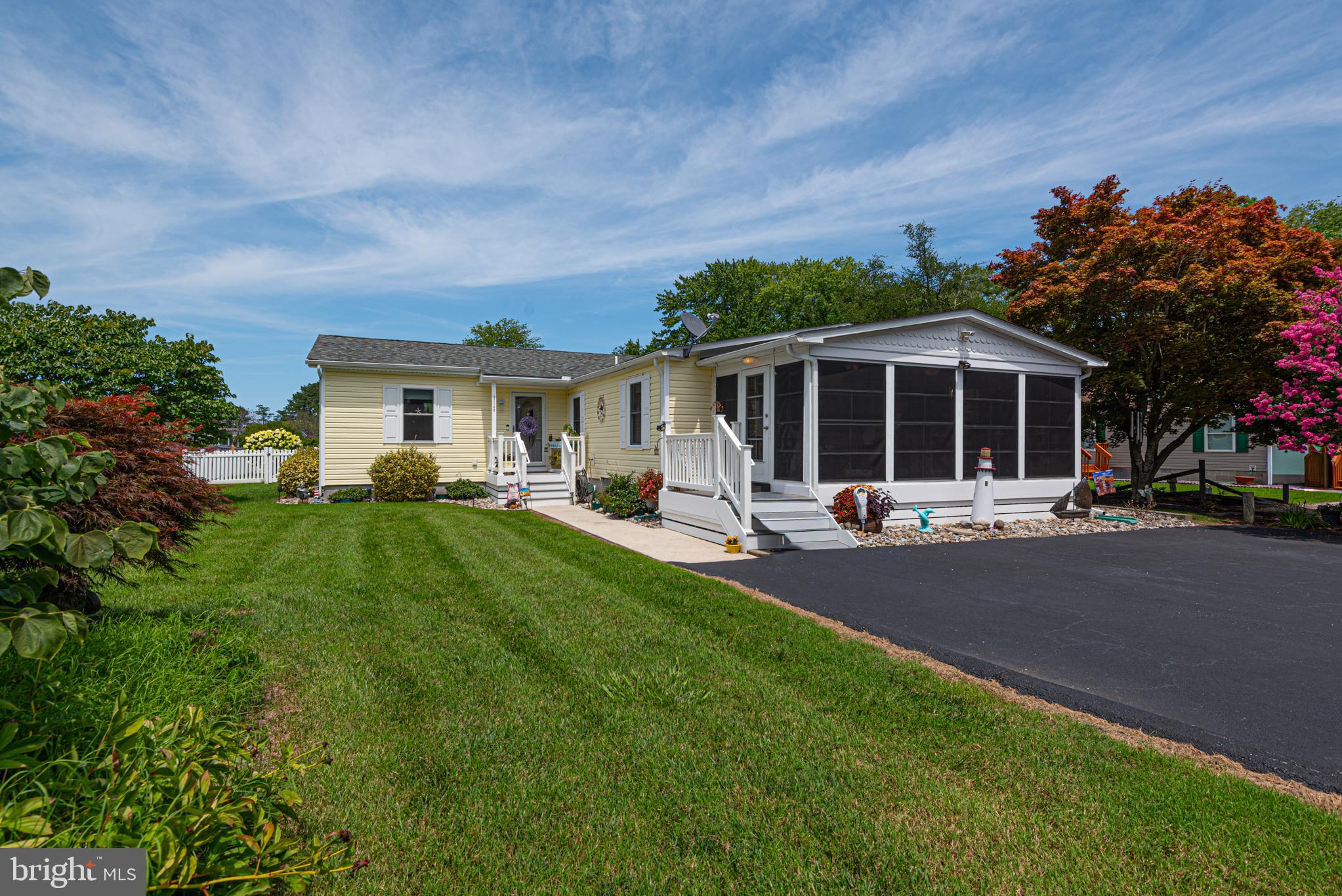 Welcome to 37189 Pinewood Rd., Ocean View, DE, a beautifully renovated 3BR, 2BA home offering approximately 1,912 sq. ft. of comfortable living space just minutes from Bethany Beach, shopping, dining, golf, and boating. Originally built in 1992, this home was extensively remodeled with a 20' x 20' addition completed in 2015, creating a spacious floor plan perfect for everyday living and entertaining.

The updated kitchen features white cabinetry, new countertops, black sink, satin-finish faucet, garbage disposal, dishwasher, glass-top electric range, and a newer refrigerator with bottom freezer and ice maker. Luxury vinyl plank flooring extends throughout the main living areas, while all bedrooms feature upgraded carpet and padding.

The spacious primary suite includes a fully renovated bath with double vanity, oversized glass walk-in shower with built-in seat and grab bars, and comfort-height toilet. The hall bath has also been completely updated with new vanity, flooring, plumbing fixtures, and comfort-height toilet.

Major improvements include new insulation, drywall, interior walls and ceilings, Tyvek house wrap, vinyl siding, soffits, gutters, downspouts, and a new roof installed in June 2023. The home is equipped with a heat pump with gas backup, public water, and public sewer.

Enjoy outdoor living from the enclosed front porch with EZ Breeze windows, three maintenance-free Trex composite decks with white vinyl railings, a concrete patio, and a fenced backyard with white vinyl privacy fencing. A matching 24' x 12' storage building with electricity provides exceptional space for a workshop, hobbies, or additional storage.

With low annual HOA dues of just $250 and extensive updates throughout, this move-in-ready home offers outstanding value in one of Delaware's most desirable coastal locations.
