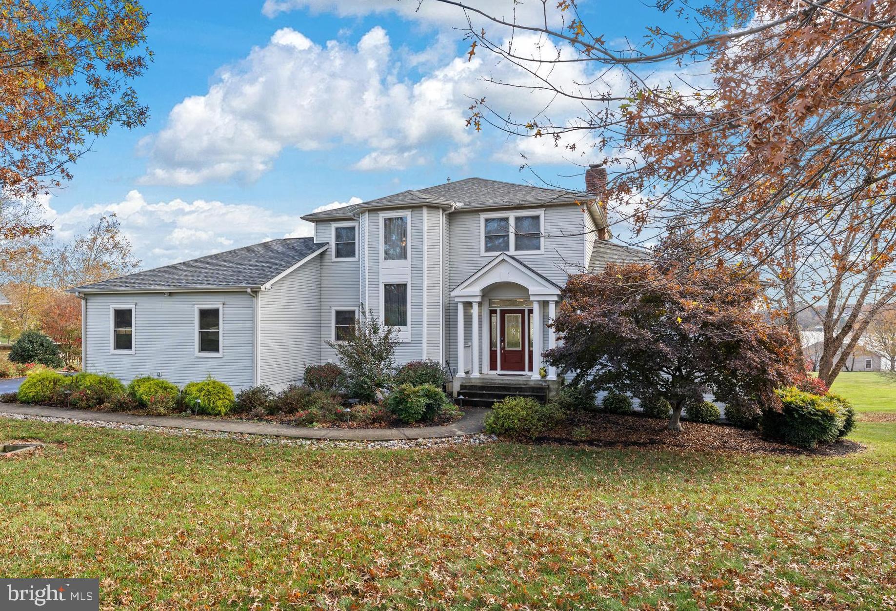 Welcome to your fully furnished, turnkey waterfront retreat—nestled on the public side of Lake Anna, Virginia. Great lake location with deep water  (8-9 feet at the end of boathouse!), this custom-built home is the ultimate escape for anyone loves peace, play, and panoramic water views. Spanning 4,400+ finished square feet across three beautifully finished levels, this 5-bedroom, 3.5-bath home is designed for comfort, entertaining, and soaking in lake life. Step into elegance with soaring 9-ft ceilings, gleaming hardwood floors, and classic crown molding throughout. The open-concept heart of the home features a cozy wood-burning fireplace in the family room, flowing into a bright breakfast nook and gourmet kitchen with stainless steel appliances, granite countertops, and a show-stopping center island perfect for gathering. Your main-level primary suite with deck access overlooks the water and features, a walk-in closet, jetted tub, and a luxurious tiled shower. Upstairs, guests and family can unwind in three spacious bedrooms and a full bath. The fully finished walkout lower level is an entertainer’s dream, complete with a 5th bedroom, full bath, second family room, wet bar, and recreation space. Outside, paradise awaits. Follow the lush, grassy lawn to your private covered boathouse with an electric lift, storage, and sundeck, ideal for morning coffee or sunset cocktails. Enjoy 200 feet of bulkheaded shoreline, a concrete patio with a built-in fire pit by the water, plus another massive patio with a second fire pit and plenty of space for lakeside BBQs. The oversized 3-car garage, paved driveway, extensive hardscaping, and 1-acre lot make this home as practical as it is beautiful. Just minutes by boat or car from Tim’s at Lake Anna, Below Deck LKA, Moo Thru Ice Cream, groceries, breweries, wineries, and more. Recent upgrades: new roof (2023), high-end HVAC systems (2023), new boathouse roof (2019), all new sliding doors (2021), and more! See MLS docs for the full list of improvements.