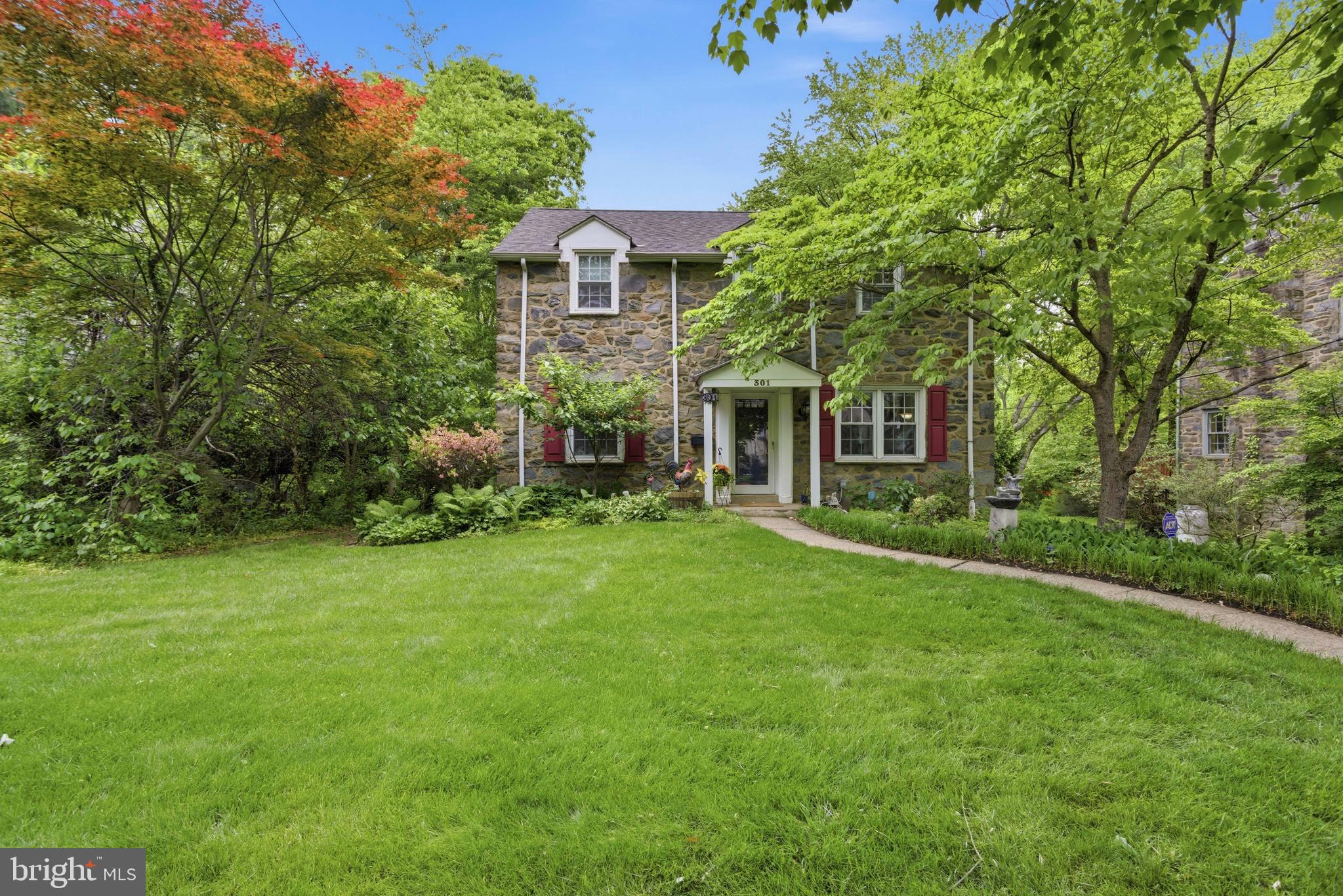 Welcome to 301 Riverview Road! This 4 bed 4 bath stone colonial is situated on a beautiful, tree-lined street in the Swarthmore Hills section of Swarthmore! Located in the award winning Wallingford-Swarthmore SD, this home has so much to offer. When entering the home you'll find the formal living room to your right with a wood burning fireplace, just perfect for spending time conversing with family and friends. To the left you'll find the dining room which leads straight into the updated, open concept kitchen and great room area. The great room boasts tons of natural light, amazing high ceilings, a gas fireplace and access to the large deck! In the great room are the stairs leading down to the office/5th bedroom addition  featuring outside access as well as a half bathroom. A second half bathroom and laundry room complete the first floor. On the second floor you'll find the master bedroom with ensuite, 3 more generously sized bedrooms and the second full bathroom. The original basement is a great size and offers many options from playroom to home gym or a second family room! Lastly in the basement you will find the mechanical room which has a french drain and sump pump, water filtration system and driveway access to the attached 1 car garage. Steps from Swarthmore Swim Club and Don Henderson athletic fields. 
Not until you have your first bbq, cup of coffee or glass of wine on the deck, can you truly appreciate the absolutely stunning property that this home sits on! Relax & enjoy!
This is Swarthmore living at its absolute finest!

**Please note that the square footage is not believed to include the family room and basement office/5th bedroom addition. Buyers are encouraged to conduct their own due diligence to verify the actual square footage!