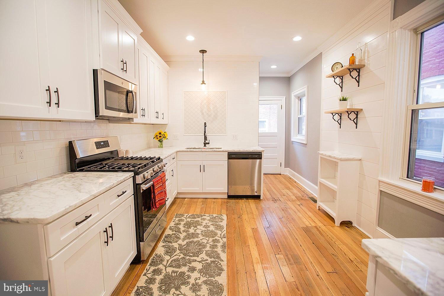 Located in the Northeast Quadrant of Lancaster City,  This 4-bedroom, 2.5 bathroom home flows nicely from room to room, with hardwood floors throughout. Renovated to enhance its natural beauty while upgrading to modern day conveniences. Exposed brick and crown molding in the living room, continues into the  dining room. In the kitchen you will find a new layout featuring NEW cabinets, NEW counter tops, NEW appliances ready for the new owner. Petite coffee station with ship-lap accent wall. Marble Counter Tops throughout the kitchen.  A half bath is tucked behind the kitchen, leading into a nice rear yard. On the 2nd floor, a full bath sits at the top of the stairs with a bedroom and rear back porch for sitting. 2nd Flr Laundry room with custom folding table. Large Master w/bay window.  Custom dual concrete counter top and subway tiled shower in the master bath. 3rd flr has 2 large  additional bedrooms.  New HVAC system, fully re-wired  and  replacement windows throughout home. Home is located a nice walk to downtown amenities and convenient to Route 30.