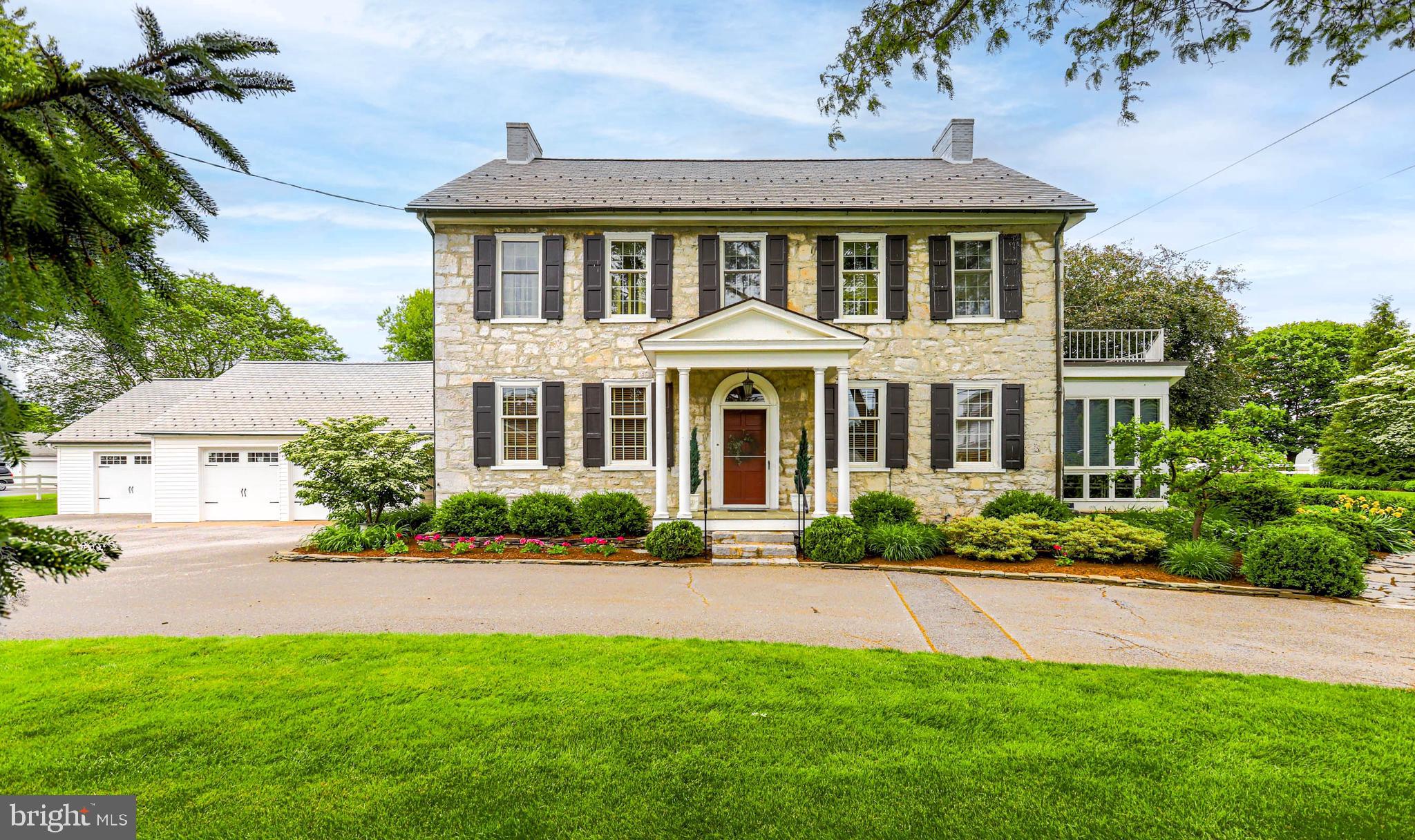Built in 1804, this beautifully maintained stone home sits on over an acre and blends historic charm with modern updates. Original restored wood floors, three gas fireplaces, and central air-conditioning highlight the home’s character and comfort. The updated kitchen and renovated primary bath offer modern convenience while preserving the home’s timeless appeal. 

Enjoy relaxing in the three-season sun room or entertaining in the finished basement, complete with marble flooring and a pool table. Numerous upgrades have been completed throughout the home, including kitchen and bathroom updates, replacement windows, updated wiring, and the house roof was replaced within the last six years. The home is serviced by public water and public sewer, with an additional well and multiple hydrants throughout the property.  Heating is provided by an oil, hot-water baseboard system.

 The outdoor living space is designed for entertaining and relaxation, featuring a covered patio, pergola, fire pit, grill area, water feature, and beautifully landscaped flower gardens across the 1+ acre property.
Additional features include a four-car garage and a private apartment above the garage, ideal for guests or extended family.  Seller will provide a home warranty for added peace of mind.