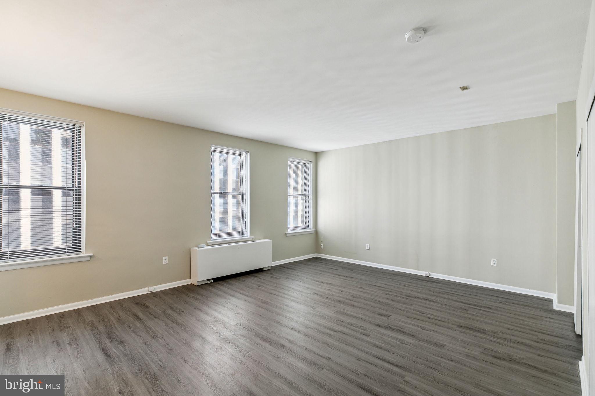 Sunlit studio apartment with new grey vinyl floors located at The Wellington on Rittenhouse Square! The light-filled living/dining area has windows beaming with natural light and two large wall closets providing ample storage space. Adjacent, there is a bright kitchen featuring wood cabinetry, white appliances, and large window. The full, hall bathroom features tile floor and a shower/tub combination with a white vanity, and an additional closet. The Wellington is a pre-war apartment building located on Rittenhouse Square offering a 24 hour doorman, on-site management, and access to a nearby fitness center at 1845 Walnut.