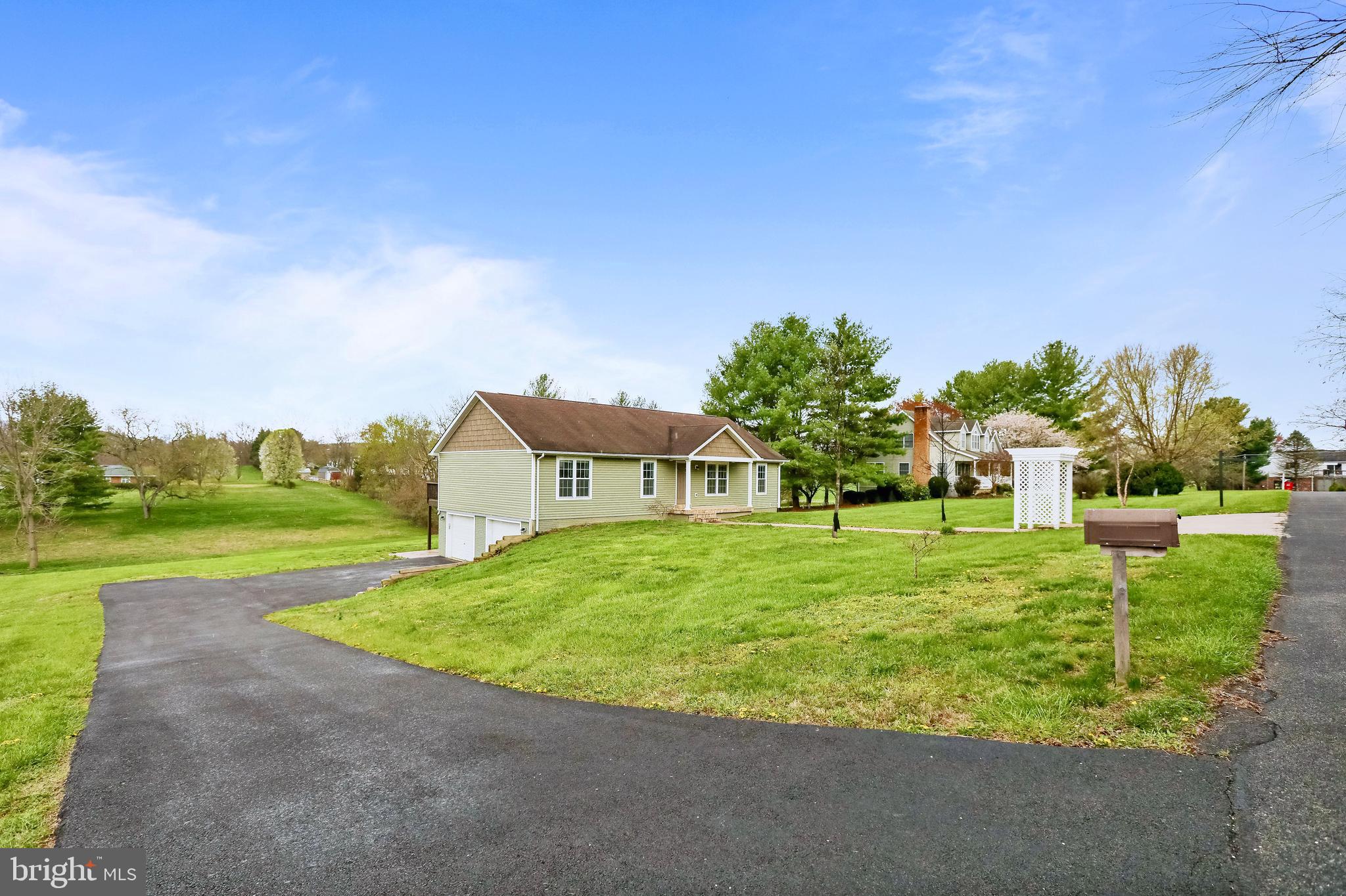 4 bedrooms, 3 full bathrooms on 1 acre of land with a spectacular view of the mountains.  Main level primary bedroom with fully remodeled primary bathroom.  Wood floors throughout main level.  Oversized 2 car garage.  2 decks and a covered front porch.  Oven replaced 2021, Washer & dryer replaced 2021, water heater replaced 2023, well pressure tank & pump replaced 2021.  Salt based water treatment filter replaced 2023.