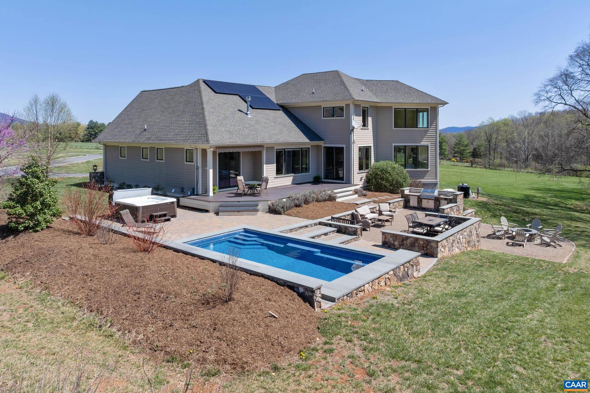 Nestled against the Blue Ridge, this distinctive Afton estate will amaze with spectacular 360 degree views! A true Net Zero property, including handsome main residence, guest cottage, barn and small vineyard. A flagstone porch welcomes you home! Open floor plan, hardwoods and exquisite finishes. Main level Owner?s Suite w/ lavish bath, gorgeous LR w/ soaring stone fireplace & captivating views of mountain & woodlands. A stunning chef?s kitchen opens to dining nook and cozy family room flanked by windows. Gleaming granite island, Thermidor range and coffee/wine bar. An outdoor retreat awaits! Heated salt pool & hot tub, dining area, outdoor kitchen & firepit, framed by breathtaking stone & babbling stream. Upper level has two bedrooms sharing a hall bath, home office and large bonus space, all with incredible views! Comfy theater/game room downstairs which opens to fabulous wine cellar, perfectly chilled for 500 bottles of wine. Huge barn w/ patio and, to top it off, there?s a detached studio cottage w/ kitchen and bath, ready for guests or vacationers! Cottage patio overlooks mountains and vineyard, perfect for crafting small batch wine. All this & located in the heart of popular Nelson151 wineries, breweries, nearby AT and more!,Cherry Cabinets,Granite Counter,Soapstone Counter,Fireplace in Family Room,Fireplace in Living Room