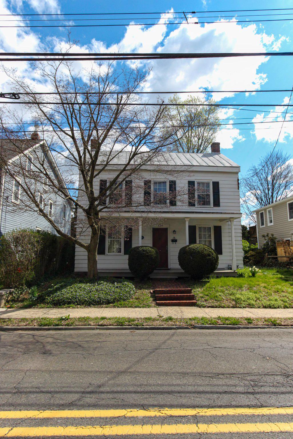 Don’t miss out on this rare opportunity to own a true piece of history. Nestled along the storied Bellevue Avenue in Langhorne Borough, originating from a Lenni-Lenape path, this property lies at the core of the town –Bellevue Avenue being part of the formation of the famed “Four Lanes End,” intersection with Maple Avenue. Settled by Quakers in the 1680s, this area became a pivotal, bustling stagecoach stop between Philadelphia and Trenton. In the late 19th and 20th centuries, it evolved into a popular, affluent summer destination. 

Inside, the home welcomes you with a charming living room from the original 1850 structure, featuring original wide-plank hardwood floors and a striking double-door cast iron fireplace with ornate detailing. The spacious eat-in kitchen offers everyday comfort and includes a convenient floor hatch to the basement.

Flowing from the kitchen is a stately dining room that opens seamlessly into a cozy den. Here, a beautifully detailed wood-burning stove sits atop a brick hearth, complemented by warm wood-paneled walls that create an inviting, rustic ambiance. A utility room with main-floor laundry and a half bath adds practicality just off the den.
Upstairs, you’ll find three generously sized bedrooms and a well-appointed hall bath. The primary bedroom also includes access to the attic, offering additional storage. Additionally, this property is set on a generous lot and includes rear parking and a detached garage.

Enjoy being within walking distance of the charming downtown, including the historic Langhorne Hotel, the second oldest tavern in Bucks County, operating since 1724. For families, Sesame Place is just ten minutes from downtown Langhorne, which offers several rides and water attractions. Playwicki Park is another family-friendly destination with playgrounds, hiking trails and fishing spots along Neshaminy Creek as well as Playwiki Farm, a 110-acre preserved historic property hosting community events. Additionally, enjoy relaxing views of the lake with scenic walking trails at the local Core Creek Park. This is a truly special home where history, charm, and modern-day convenience blend together.