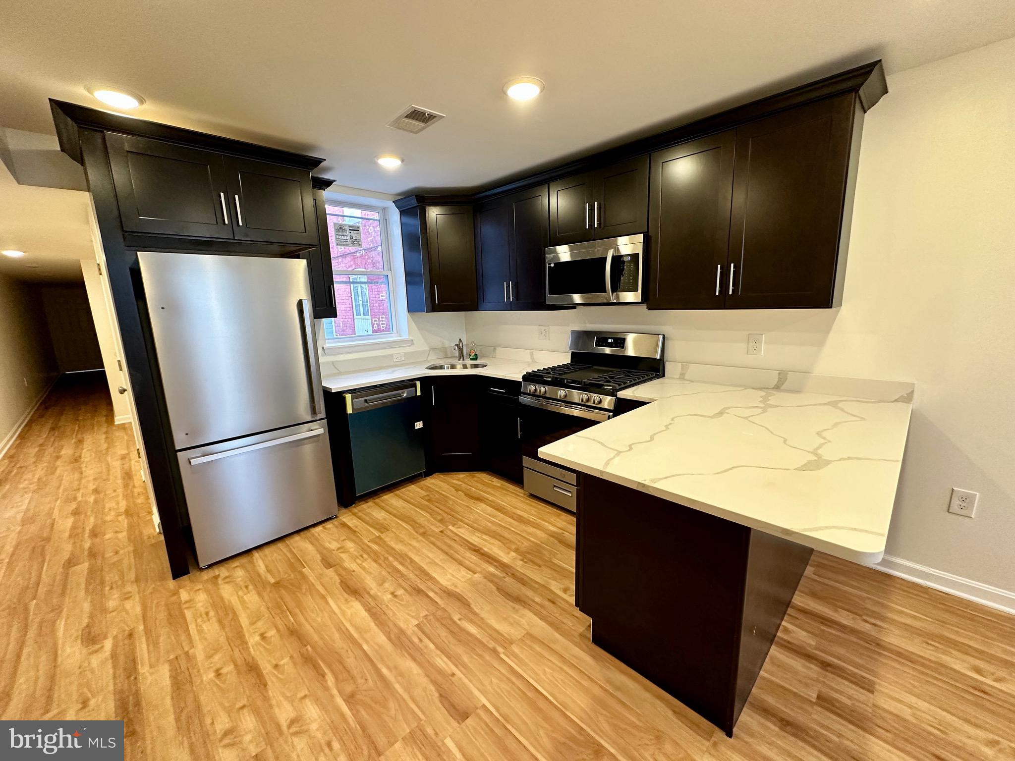 Available for immediate move in!  Newly renovated 2 bedroom, 1 full bath ground level apartment, offering modern living in a prime location. Step into this recently constructed unit and be greeted by the pristine interior featuring new stainless steel appliances, perfect for whipping up delicious meals. The convenience of an in-unit washer/dryer adds to the ease of daily living.

This apartment boasts luxury vinyl plank flooring (LVP) throughout, providing durability and style, while recessed lighting and ceiling fans offer comfort and ambiance. Pets are considered on a case-by-case basis. The back patio is shared with unit above.  Outdoor furniture has been provided for use by the owner.  650+ credit score is required. Tenant responsible for BGE/Electric/Water. 

Conveniently located within walking distance to dozens of restaurants, as well as the iconic Little Italy and Inner Harbor, residents will delight in easy access to the city's best dining, shopping, and entertainment options. Additionally, Harbor East, known for its upscale shops, restaurants, and waterfront views, is just a short stroll away, adding to the vibrant urban experience.

For healthcare professionals, Johns Hopkins Hospital is just a twenty-minute walk away or a quick 5-minute bike ride, ensuring a stress-free commute. With Whole Foods also within walking distance, fresh groceries and gourmet treats are always within reach. Additionally, the Johns Hopkins Carey School of Business is a mere 10-minute walk away, making this apartment an ideal choice for students and faculty alike.

Don't miss out on the opportunity to call this brand new apartment home, where convenience, comfort, and modern living converge in one desirable location.