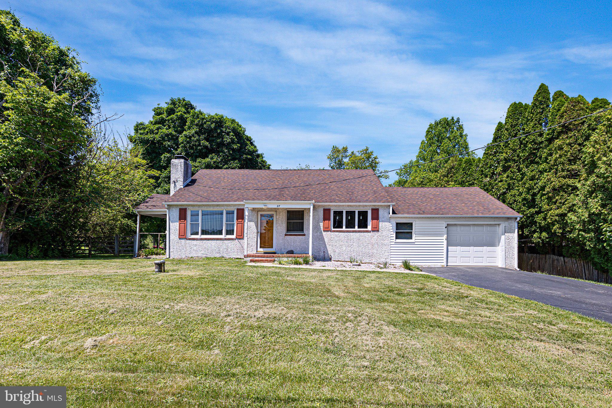 Welcome to 27 Wedgewood Rd in Newark!  Nestled just outside the city limits with no HOA restrictions, this charming move-in ready ranch offers the perfect blend of comfort, space, and privacy.  Step inside to an inviting open-concept layout featuring the living room, dining area, and kitchen, ideal for both everyday living and entertaining.  The kitchen is filled with natural light from a large triple window and features recessed lighting, pendant fixtures, a double-bowl sink, and abundant cabinet and counter space.  The cozy living room showcases a classic wood-burning fireplace with brick surround, built-in cabinetry, and original hardwood floors waiting beneath the carpet.  The main level also includes three generously sized bedrooms and a full bathroom.  Just off the living room, a spacious covered porch creates the perfect outdoor retreat for relaxing or enjoying peaceful evenings.  Upstairs, a huge finished bonus room provides endless possibilities for a home office, playroom, guest space, or hobby area. The basement offers a laundry area, built-in workbench, and plenty of additional storage space.  Conveniently located off the kitchen, the oversized one-car garage features a WiFi-enabled lift and direct access to the rear yard.  Outside, you’ll find a large wooden deck overlooking the private countryside setting with a fenced in rear yard.  Recent updates provide added peace of mind, including a new well and septic system in 2013, roof replacement in 2010, HVAC system in 2015, updated electric panel in 2000, refrigerator replaced in 2023, and a new water heater installed in 2026.