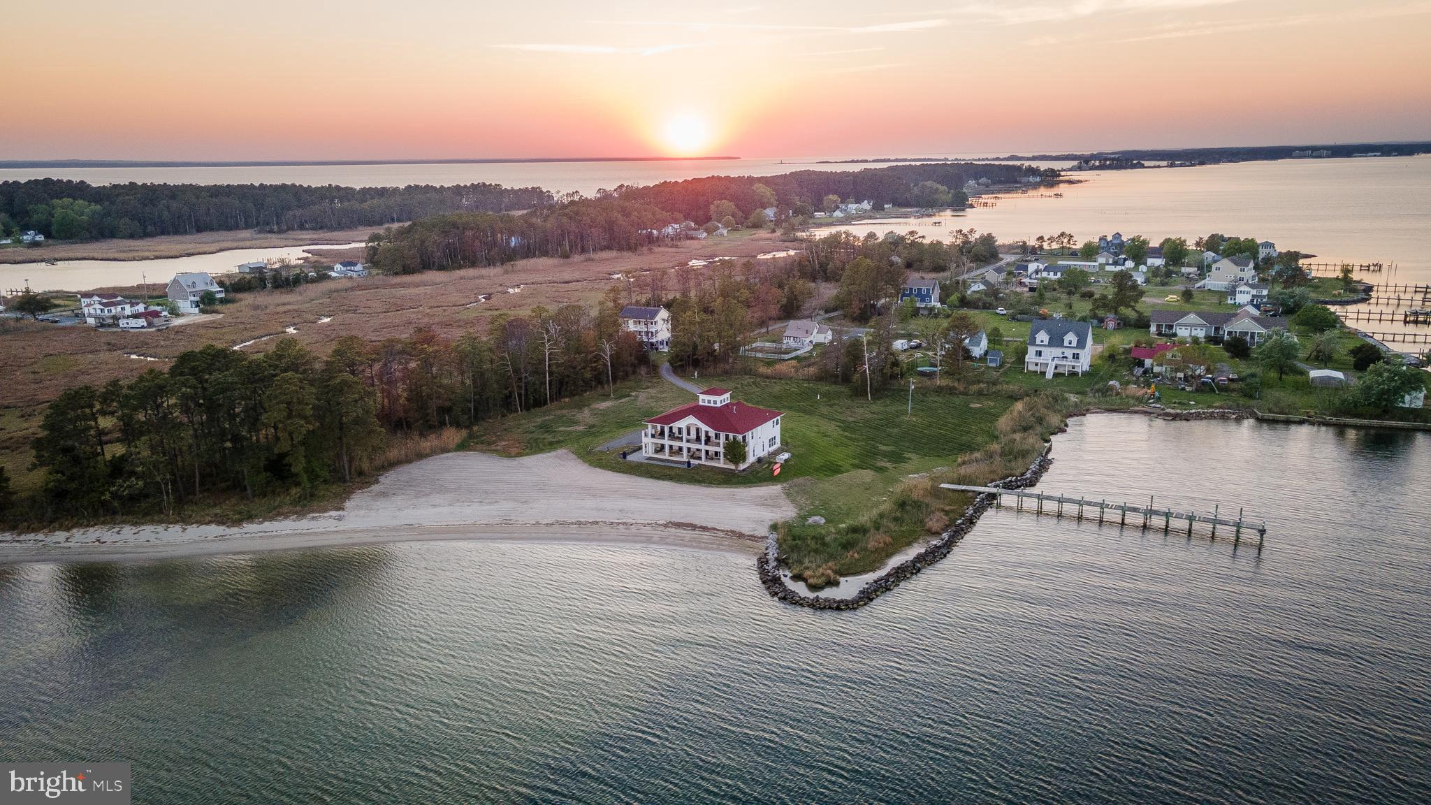 Own your own private beach on the St. Marys River with over 300 feet of pristine white sand. This exceptional property boasts more than 700 feet of total waterfrontage, spanning both the river and St. George’s Creek, delivering unmatched views and privacy.

Custom-built 2-story home offering over 4,000 square feet of living space. The kitchen and great room capture sweeping river views through three sets of double glass doors, complemented by soaring ceilings and an open cupola that fills the home with natural light. The main-level primary suite enjoys water views on both the river and creek sides and features a second gas fireplace.

Experience sunrises on one side, sunsets on the other, and moonrises shimmering over the river.

The main level includes 3 bedrooms, 2 full baths, a spacious walk-in pantry, laundry room, and a flexible space ideal for a dining room or home office. Step outside to a 60’ x 12’ covered patio with panoramic waterfront views.

The lower level is perfectly suited for guests or income potential, featuring a full second kitchen, additional laundry with second washer and dryer , family room, third full bath, and a flexible guest area with movable privacy glass walls to create two additional bedrooms . A second 60’ x 12’ covered porch extends the living space outdoors. Currently utilized as a successful Airbnb, with records available.

Additional highlights include a private dock, public sewer, stamped concrete walkways, all-brick construction with a durable metal roof, and an oversized 2-car garage with studio/workshop space. Beautifully landscaped for a polished coastal setting.  Close proximity to Potomac River & Chesapeake Bay.

Pre qualified buyers please.