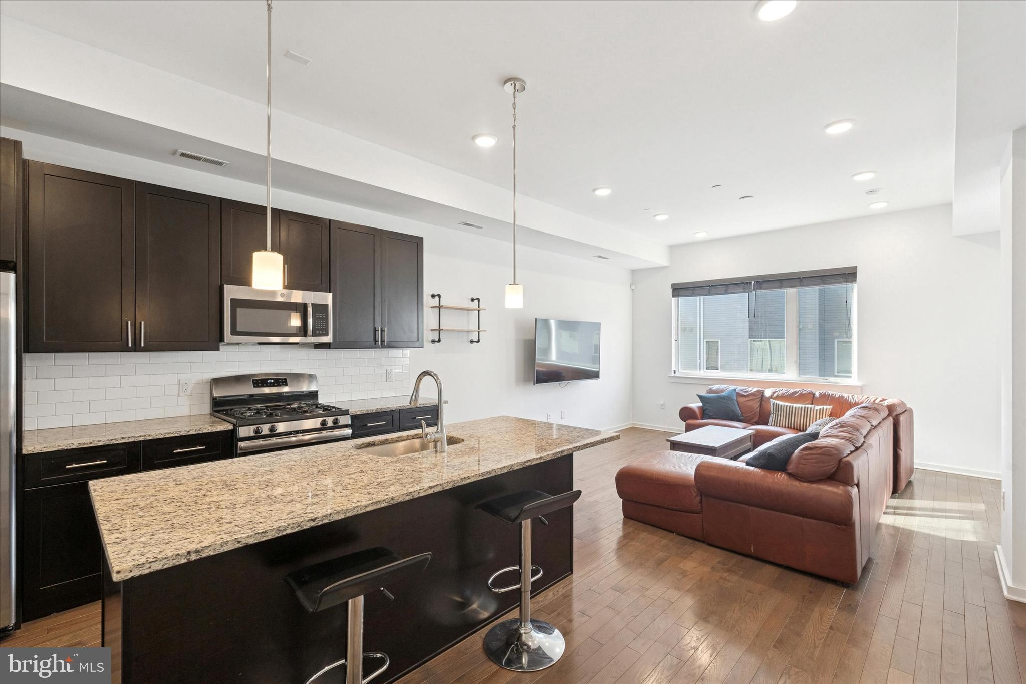 Welcome to N5 square, a vibrant community in the heart of Olde Kensington - one of Philadelphia most growing and sought after neighborhoods! This development, built in 2019, delivered 57 new homes and commercial shops to the neighborhood and is located just minutes from so many of the city's top restaurants, coffee shops, bars, and boutique shopping! This seven years young one bedroom, one bathroom condominium conveniently located on the second floor has it all including PRIVATE, COVERED OUTDOOR SPACE, washer and dryer in unit, hardwood floors throughout, granite countertops and stainless steel appliances, and approx 3 years left on FULL TAX ABATEMENT. Notice the large windows and glorious natural light that floods the space. Perfectly functional open layout which maximizes the space and makes living here a breeze. Large great room with tons of living and dining space. Enjoy the large kitchen island, great for cooking and entertaining! Head back to the bedroom with a large closet, and full bath in the hallway but just outside of the bedroom door. Enjoy modern convenience walkable to so much including: Frankford & Girard Ave, El station,Temple University, Luna Cafe, LMNO, Suraya, Stateside Vodka Sutton's Bar, Poe's Sandwich Joint, ReAnimator Coffee, La Colombe Coffee, Fishtown Market and many more! Stroll down into Northern Liberties in minutes! Easy access to 95 to get in and out of the city!