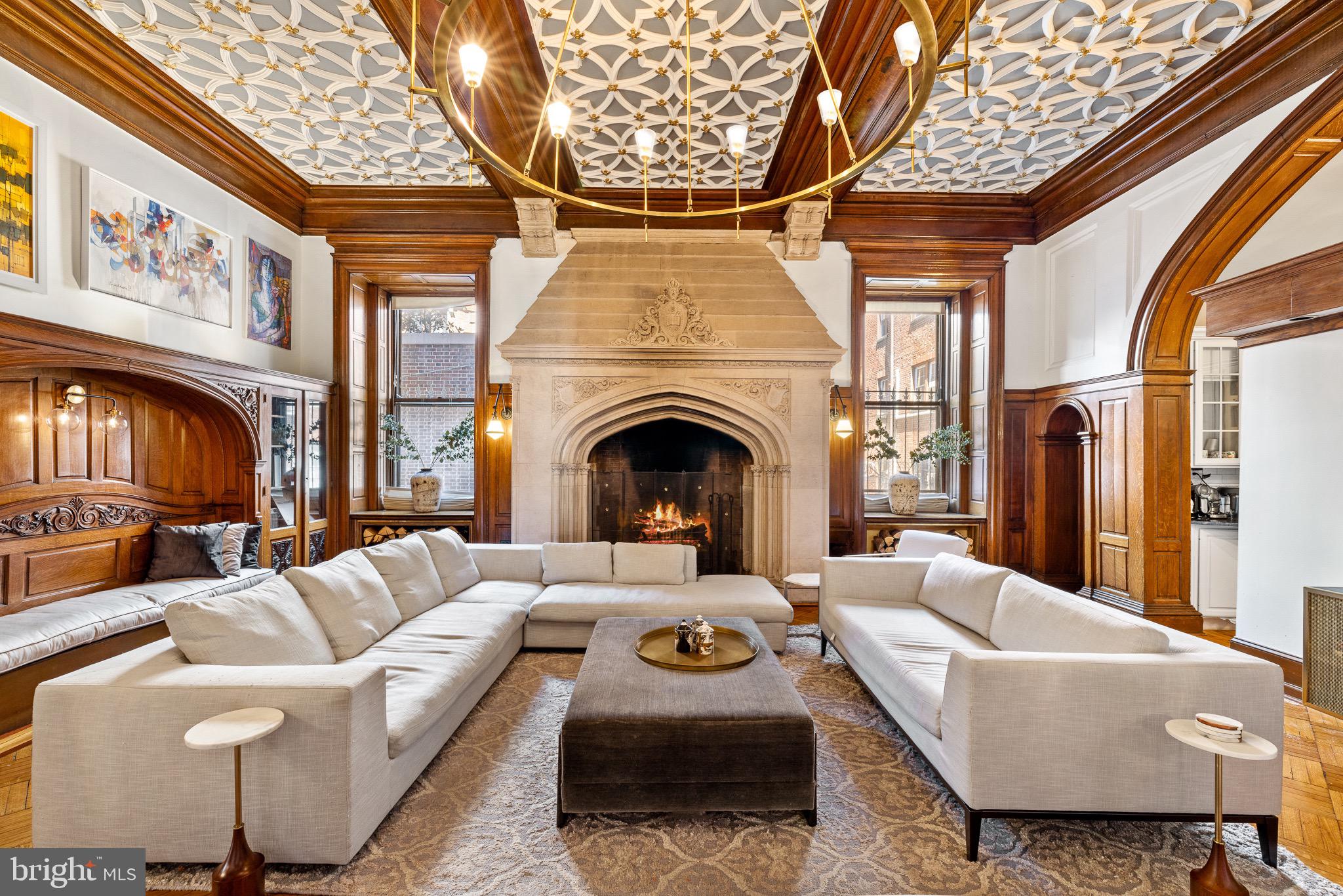 Welcome to your own piece of Philadelphia history at Chandler Place — an extraordinary residence in the heart of coveted Fitler Square,  with the convenience of private deeded 1-car parking.

Approached through a tranquil courtyard beneath a canopy of mature trees, the building welcomes you through a private entrance, setting the tone for the refined blend of heritage and elegance that unfolds inside.  Upon entering through the double glass-enclosed foyer, a beautifully detailed decorative plaster ceiling immediately highlights the home’s historic craftsmanship.
The formal living space impresses with soaring ceilings, oversized windows, and original architectural details. Hardwood floors with intricate walnut and mahogany inlays, elaborate moldings, and beautifully preserved woodwork reflect craftsmanship rarely found today. Ideal for entertaining, the visually stunning formal living area greets you with meticulously preserved parquet floors, intricate molding and woodwork, anchored by a grand fireplace that adds warmth and architectural presence. The kitchen features granite countertops, white shaker-style cabinetry with abundant storage, and stainless steel appliances including double convection ovens
The main-floor bedroom suite features dramatic 14-foot ceilings, expansive windows, original parquet flooring, a mahogany mantel fireplace, and a generously sized closet. Thoughtfully designed with a coffee bar and its own en-suite bath, the space offers both comfort and flexibility.
A sweeping staircase leads to the second bedroom suite, accompanied by a versatile office area near the landing. Enclosed laundry area with brand new washer & dryer . This private retreat features a decorative fireplace, large custom wardrobe, and a beautifully appointed spa-inspired bath with a Hansgrohe steam shower, sculptural soaking tub, double vanity, and floor-to-ceiling stone tile, creating a serene atmosphere of modern luxury .
Originally designed in 1904 by renowned architect Theophilus Chandler for the Episcopalian Bishop of the Pennsylvania Archdiocese, this distinguished mansion represents a remarkable chapter of the city’s architectural legacy. In 1980, celebrated architect Otto Spur thoughtfully transformed the estate into exclusive condominium residences, preserving its historic grandeur while introducing modern comfort. Today, this residence offers the opportunity to become the next steward of a significant Philadelphia landmark.
This pet-friendly residence enjoys one of Philadelphia’s most desirable locations — perfectly positioned minutesfrom Rittenhouse Square and the Schuylkill River Trail, with world-class restaurants, boutique shopping, and cultural landmarks just moments away.

Chandler Place offers a rare opportunity to live within one of Philadelphia’s enduring architectural treasures, where history, craftsmanship, and modern city living converge.