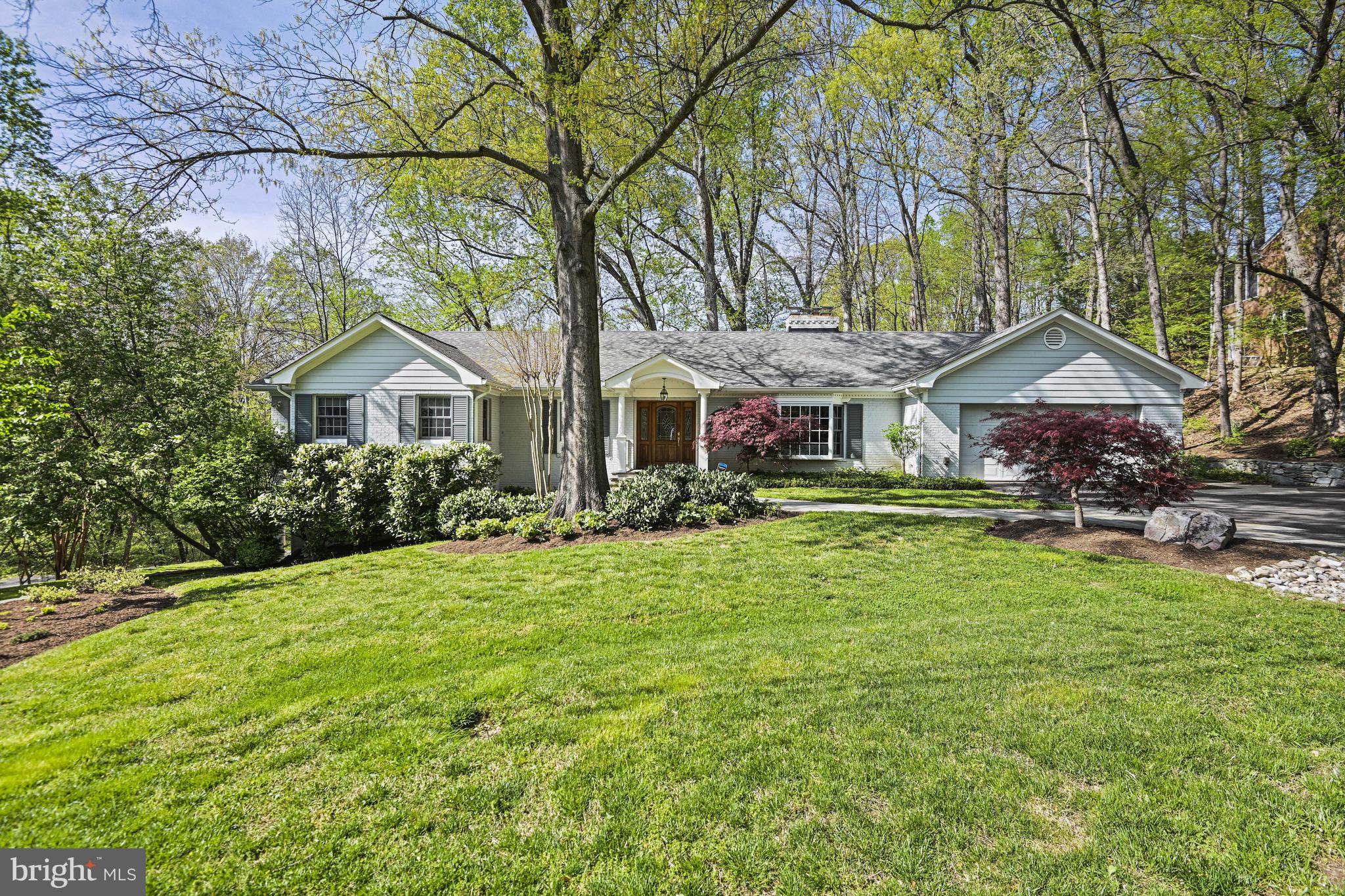 Welcome to this beautifully expanded home in sought after Chesterbrook Woods featuring rarely available Main Level Living!  Located in a private setting with views of Pimmit Run, this move-in-ready 5 Bedroom, 5 Full Bathroom home with over 4500sf provides open and airy living spaces, a gorgeous Primary Bedroom Suite, and a spacious walk-out lower level with 9-ft ceilings.  The main level living area features gleaming hardwood floors throughout, an expansive and light-filled gourmet Kitchen with 42” wood cabinetry, stainless steel GE Monogram appliances, a massive island and space for a breakfast table.  The adjacent Family Room with Fireplace and built-in desk area overlooks the backyard through a magnificently large set of windows while the Laundry and Mudroom provide multiple organization and storage options as well as direct access to the 2-car Garage. The Dining Room accommodates a large table and opens to the expansive rear deck.  The Living Room at the front of the home is a quiet and peaceful respite and offers a Fireplace as well.

The Main Level Primary Bedroom Suite is generously sized to more than accommodate a king sized bed and includes a custom built-in sitting area with spectacular views of nature.  The Primary Bathroom is beautifully finished with an oversized dual sink vanity, large shower with frameless glass door and bench, soaking tub, separate water closet, and a large walk-in closet.  Bedroom 2 comes with a walk-in closet and en suite Bathroom with Shower.  Bedroom 3 accesses the Full Hall Bathroom.  

A separate private Office with built-in desk and bookshelves is accessed on the way to the Lower Level and makes work-at-home a breeze.  Prepare to be wowed by the open and spacious nature of the walk-out Lower Level with soaring 9-ft ceilings, tons of natural light.  The Rec Room offers a wet-bar and Fireplace, and direct access to the private covered patio for quiet evenings or morning coffee.  Bedroom 4 has an en suite Bathroom and walk-in closet while Bedroom 5 accesses the Full Hall Bathroom.  A Workshop and additional Storage Room complete the lower level. 

Just 1 light to DC and minutes to the Chain Bridge, Chesterbrook Woods is one of McLean’s most sought after neighborhoods providing a peaceful feel, access to nature, and connection to community.  Close to both Arlington and Fairfax County parks.  Connected neighborhood streets are ideal for taking a stroll throughout the day.  Conveniently located close to Arlington, downtown McLean, Tysons, NW DC, and commuter routes.  Come delight in the ease of main level living with beautiful spaces to share and enjoy.