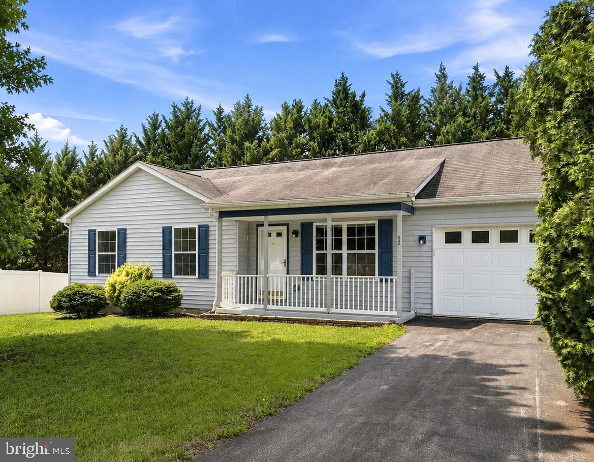 Welcome to 42 Pacific Blvd conveniently located just minutes to the grocery store, restaurants, Hedgesville High School, and commuter routes.

This one level home features a paved driveway, covered front porch, and an oversized attached garage. Inside, you'll find a flowing floor plan with durable vinyl plank flooring and neutral paint colors.

The kitchen opens to a covered back deck overlooking the fenced backyard. Mature trees provide a nice sense of privacy, and two storage sheds offer additional space for storage or a workshop area.

Down the hall are three bedrooms along with a generously sized full bathroom. If you've been looking for the convenience of one level living in an established neighborhood, this home is one you won't want to miss. Washer and dryer convey!