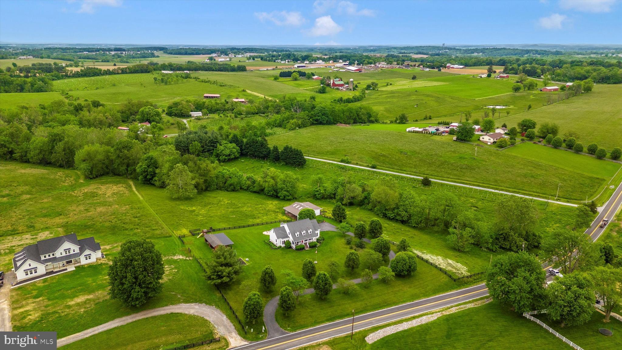 Turnkey perfection in the heart of the sought after and incredibly desirable Union Bridge community. TWO barns, paddocks and VIEWS for miles.  This desirable property is secluded from the hustle & bustle yet convenient to all major arteries. This farmette finds itself less than 45 minutes from the major metropolitan areas.   This impeccable estate is just under 10 acres featuring a gorgeous custom designed Creole Cape Cod of timeless quality construction -2 x6 exterior construction, 9 1/2' ceilings, 50 yr architectural shingles, solid oak hardwood floors as well as all new appliances in 2022.  The heart of the home features a spectacular gourmet light filled kitchen perfect for the in home chef or entertaining with ease on a larger scale.   In the kitchen, you'll enjoy picturesque granite countertops, rich designer cabinetry, a wall oven including a microwave/oven combo, electric induction stovetop with convection oven and a retractable downdraft fan.   A short walk through the dining room, family room with cozy fireplace and formal living rooms and you've reached the main level primary bedroom.     The relaxing primary bath is the embodiment of luxury with a programmable heated tile floor, stacked stone wall, luxe fireplace and clawfoot cast iron soaking tub. A walk in shower with dual shower heads, private water closet and Bluetooth speaker adds to the reserved level of ambience . The cathedral ceiling with skylight and spacious walk  in closet offers tremendous additional space. The cozy propane fireplace is the focal point of the family room that opens to a brand new outdoor deck space and continues onto the expansive low maintenance composite deck.  The walkout lower level features deep plush theatre seating and movie room, media closet and den/office.   In addition to brand new appliances, the new owners will appreciate a dual hot water heater system that provides consistent hot water to the entire household. The winding driveway is lined with fruit and flowering trees that add beauty to the mature landscaping around the home which is encased with perennial flower beds, mature shrubs and a grape arbor. 4 board oak and high tensile solar electric fencing and access to the meandering Isaiah Creek add perfect turnout for horses, cattle, llamas or the livestock of your choice.  2 barns, a chicken house with an enclosure are situated on several paddocks creating perfect rotation and turnout.  The sellers kindly share and offer their 2- custom constructed raised garden beds, a greenhouse, a large firepit, a 2 person sauna and a brand new children's playset to provide hours of activity and at home enjoyment.  This one of a kind custom estate home in the heart of Frederick County's tranquil countryside is a total luxury package with a list of must haves that simply will not last.