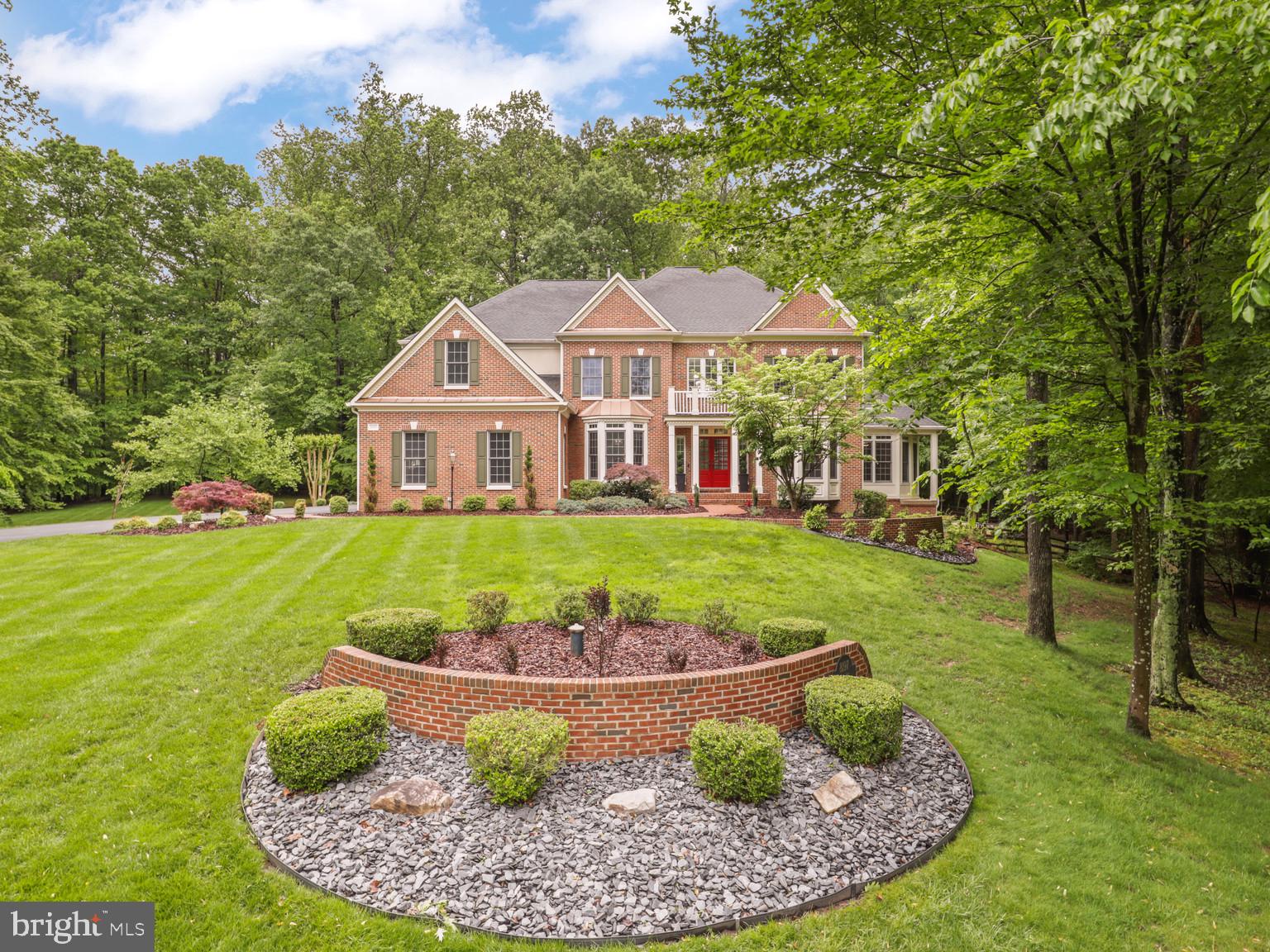 A substantial price adjustment for this Private Oasis; Elegant Estate on 5.5 Wooded Acres.  
OPEN HOUSE Saturday, 4/4/2026 From 12-3 PM. 
Welcome to an extraordinary Appx. 8284 square-foot luxury residence nestled on 5.5 wooded acres in the prestigious Estates at Roseland, southern Fairfax County. This beautifully maintained home offers a harmonious blend of modern family living and serene privacy, situated on  a quiet cul-de-sac away from urban noise. Main Level Features:- Step into a grand two-story foyer with gleaming hardwood floors that flow seamlessly throughout the main level. The heart of the home is a gourmet chef’s kitchen, featuring an expansive center island, Thermador Masterpiece Series appliances with WiFi control, Wolf Designer cabinetry, a custom pantry, designer sinks, and smart faucets (reverse osmosis)—perfect for culinary enthusiasts. The spacious family room boasts a dramatic two-story ceiling and a stunning two-sided gas fireplace, adorned with quartzite stone on one side and limestone on the other, creating a warm and inviting atmosphere for gatherings or relaxing evenings. Enjoy formal living and dining rooms, a sunroom, and a conservatory—ideal for hosting elegant dinners and special occasions. A professional office provides a quiet, inspiring space for work or creative pursuits. Step outside onto an enormous two-level deck with original Trex decking and a screened-in gazebo, perfect for outdoor entertaining. The property also features a heated pool and jetted hot tub with WiFi control, as well as a scenic trail that winds along the creek through the grounds. Upper Level:- Upstairs, the lavish owner’s suite serves as a true sanctuary, offering breathtaking views and ample space to unwind. The spa-inspired ensuite bathroom includes an oversized tub, walk-in shower, and dual vanities for ultimate relaxation. Two walk-in closets and a dedicated dressing area provide exceptional storage and convenience. The upper level also includes three generously sized secondary bedrooms and two additional bathrooms. For added convenience, there are two laundry rooms, including a newly built elegant laundry room on the second floor with smart washer and dryer, custom cabinetry, and a marble backsplash. Lower Level:- The expansive lower level is designed for entertaining, featuring a bright recreation room ideal for gatherings, movie nights, or game days. A private fifth bedroom and full bath offer a comfortable retreat for guests. There’s ample space to create a home gym, media room, or hobby area tailored to your lifestyle. The large utility room hosts a second set of washer and dryer, a state-of-the-art EcoWater water system with smart app, and a UV light water filtration system. A spacious storage room provides plenty of space for seasonal items or additional supplies. This level offers direct access to the outdoor swimming pool, patios, and beautifully landscaped backyard, making indoor-outdoor living effortless. Community & Lifestyle:- Enjoy a relaxing drive through this tranquil, well-designed wooded community every day. The Estates at Roseland offers a peaceful retreat from the bustle of city life, with private outdoor spaces and luxurious amenities for the ultimate living experience. Experience the perfect blend of elegance, comfort, and modern convenience. Schedule your private tour of this exceptional residence today!