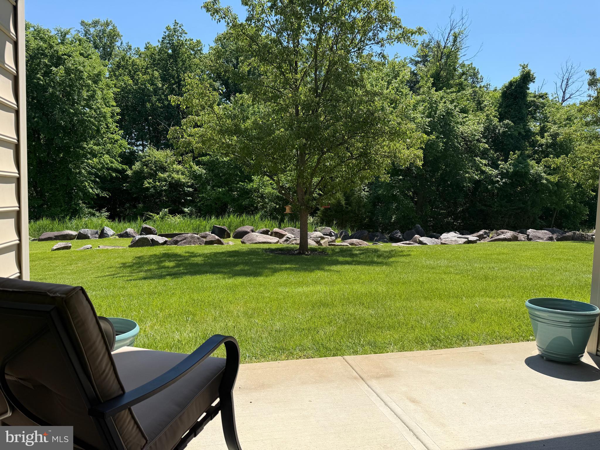 COMING SOON! What a view from the largest model condo in Creekside Village and what an amazing location too! This beautiful 1,486 sq ft Arlington Model is one of the few condos with sliders that walk right out to your private and serene back yard! You can get out of your car and walk right around to the back of the building if you choose and never even enter the beautiful lobby that is currently being remodeled. Step right out of your living room on to your patio and enjoy the gorgeous, serene back yard with mature and beautiful landscape, all while someone else is responsible for maintaining it! The fact that this is a corner unit with windows on 3 sides also makes this one a rare find as there are more windows than most units and no neighbor on either side of you either! Right outside your foyer door there is a spacious storage closet/pantry and even an exit from that level to outside, again without going thru the main part of the building. A storage unit is even included at the end of the hall. The gorgeous kitchen is bright and boasts lovely quartz counter tops and the view while you are eating or even washing the dishes is just amazing! Lighted ceiling fan is over the table, and a lovely hanging light is over the breakfast bar. This house is so bright no matter which room you are in! The living room is spacious and has a ceiling fan and over sized sliders to the rear patio. Never leave your sofa, and the view is magnificent! There is an extra room that currently being used as an extra den but could easily be a formal dining room or even enclosed to make a 3rd bedroom and also has beautiful windows for extra light. There is a hall bathroom which has a pocket door to divide the shower from the toilet/hall and guest room too. The master bedroom is so beautiful and the views, again, are breath taking. A double closet is a plus and the convenient, ceramic tile master bathroom is lovely with double sinks and a shower.  Blinds are in every room. This house is a rare find, it's location is awesome and it's in gorgeous condition. Creekside Village is not just a beautiful home, it's a lifestyle. It offers a clubhouse, swimming pool, fitness center, walking trails, tennis courts, bocci ball, putting green, dvd library, pool tables, card tables and many activities for those who want to participate. Water, sewer, lawn maintenance, snow removal, trash and exterior maintenance are all included. Public transportation is close by as are so many major arteries and just minutes from tax free shopping in Delaware, simplicity plus! This home is just beautiful! It will never last so make your appointment today!