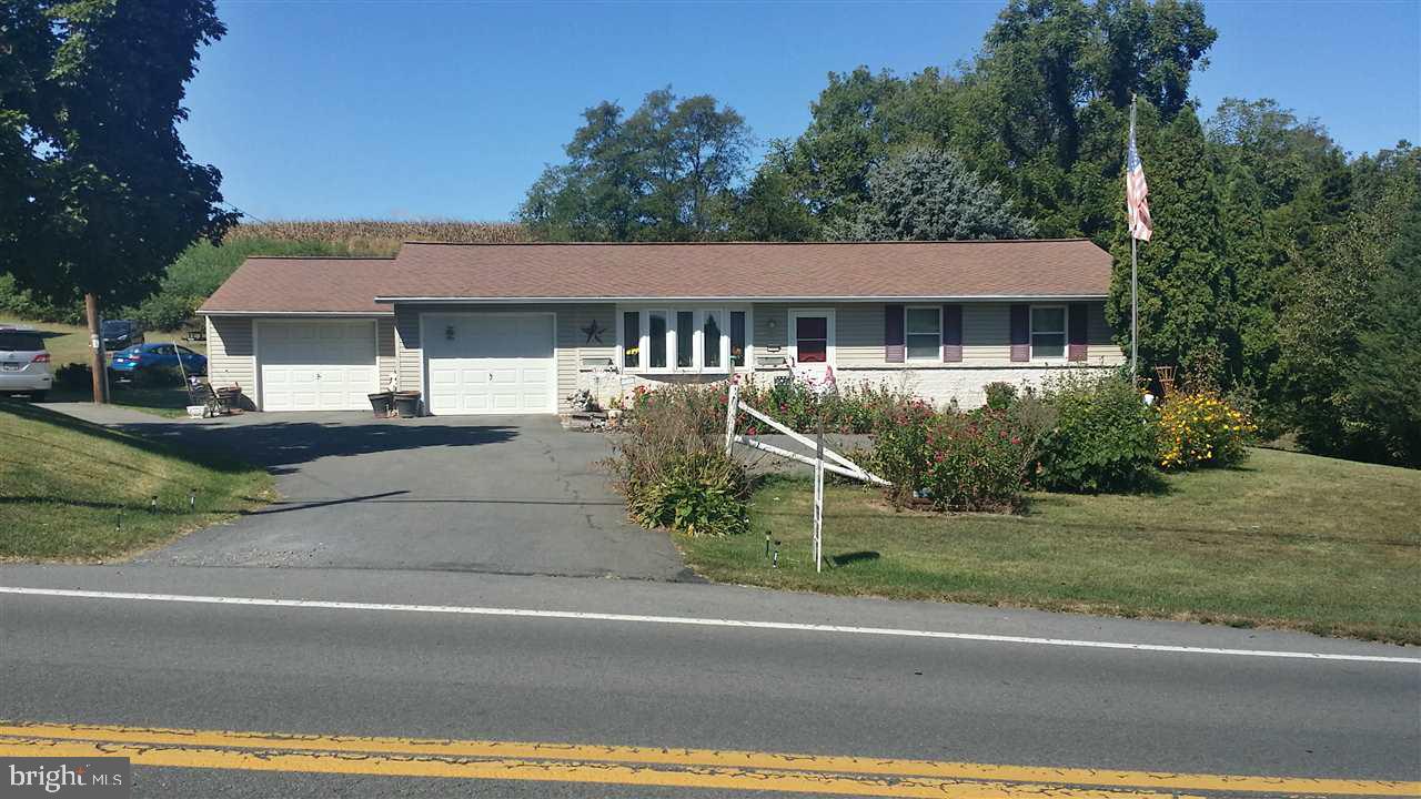 Garden Fresh Veggie, Farm Fresh Eggs, & a Country Store...this home is in a country community that has it all! This beautiful country home is situated on over an acre of land adjacent to farms. Large pole barn on property w/electric is perfect for the car collector, mechanic or possibly a guest house. Inside are 3 bedrms, 1.5 baths & a beautifully finished bsmt W/gas FP. Many upgrades & improvements including blue light water purification sys. Only 35 min frm Harrisburg, this home has all country charm.