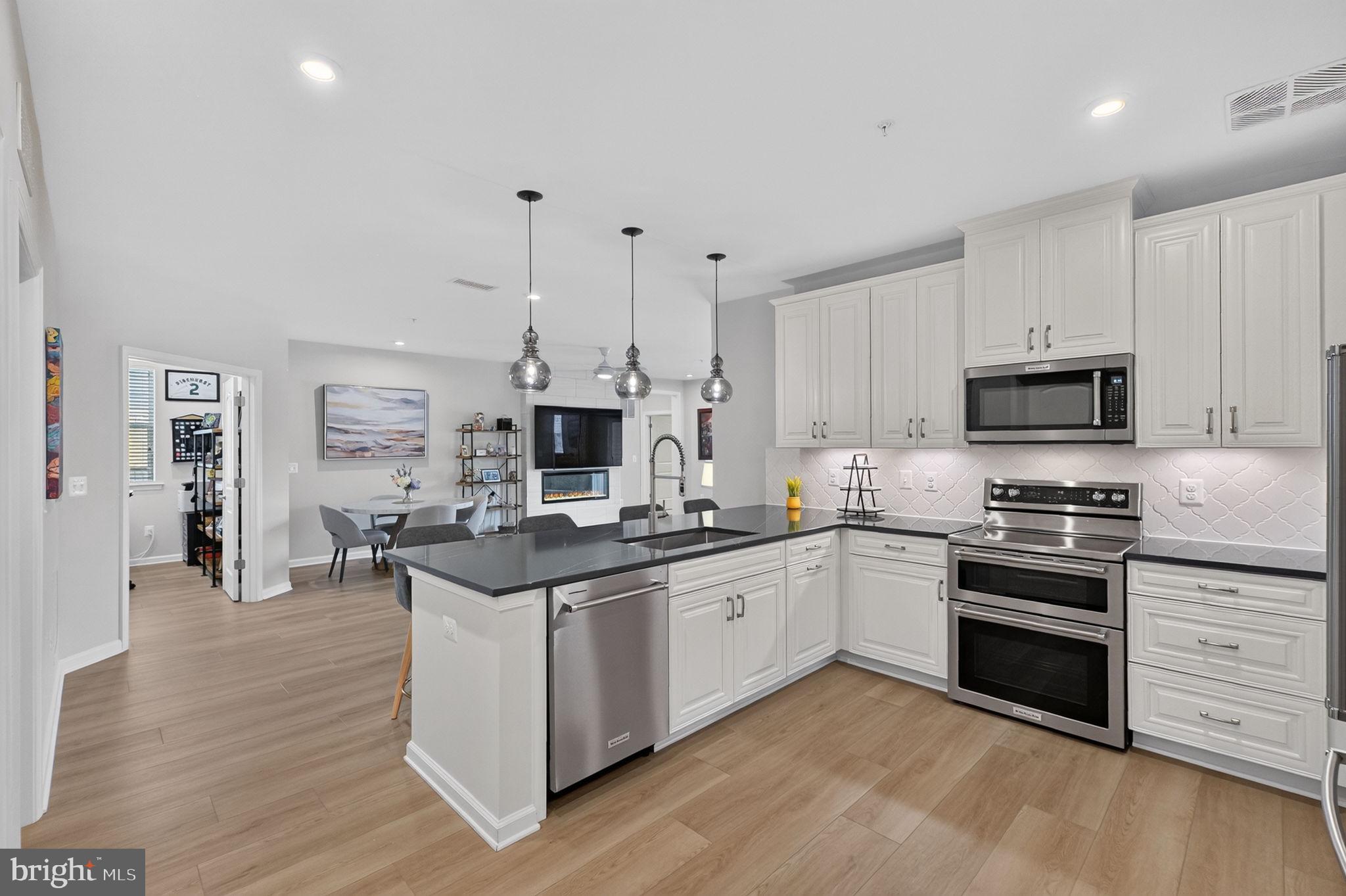 Built in 2025, this charming 55+ residence features an open floor plan that invites warmth and connection, making it an ideal space for both relaxation and entertaining. Step inside this Wiltshire, the largest offered model, to discover a beautifully appointed interior, complete with upgraded countertops, LVP flooring and stainless steel appliances in the gourmet kitchen. *THREE large bedrooms plus a private office* The spacious family room, conveniently located off the kitchen, is perfect for gatherings, while the dining area provides a lovely setting for meals. Enjoy the convenience of a walk-in shower in the primary bath and the luxury of a huge walk-in closet, ensuring ample storage for your belongings. Additional features include recessed lighting, built-ins, and a cozy fireplace that adds a touch of elegance and comfort. The unit also boasts a balcony, perfect for enjoying your morning coffee or unwinding in the evening. With a front-loading washer and dryer conveniently located in the unit, laundry day becomes a breeze. The attached garage and private driveway provide easy access and ample parking for you and your guests. Living in The Gatherings at Cabin Branch means embracing a lifestyle enriched by community amenities. Residents can enjoy a variety of facilities, including a clubhouse, fitness center, game room, golf simulator, theater room, yoga room and pickleball courts. The community center serves as a hub for social activities, fostering connections among neighbors. With custodial services and common area maintenance included in the association fee, you can spend more time enjoying life and less time worrying about upkeep. The surrounding neighborhood is equally inviting, featuring nearby parks and walking trails that encourage outdoor activities and relaxation. Walk across the street to Black Hills Park, lake and trails! Public services are easily accessible, ensuring convenience for all residents. This exceptional property not only offers a beautiful home but also a vibrant 55+ community where you can thrive. Experience the perfect blend of comfort, convenience, and camaraderie in this delightful senior community. **GREAT VALUE when compared to new construction - great price and has extra goodies that the new units just don't offer. Come see for yourself! **