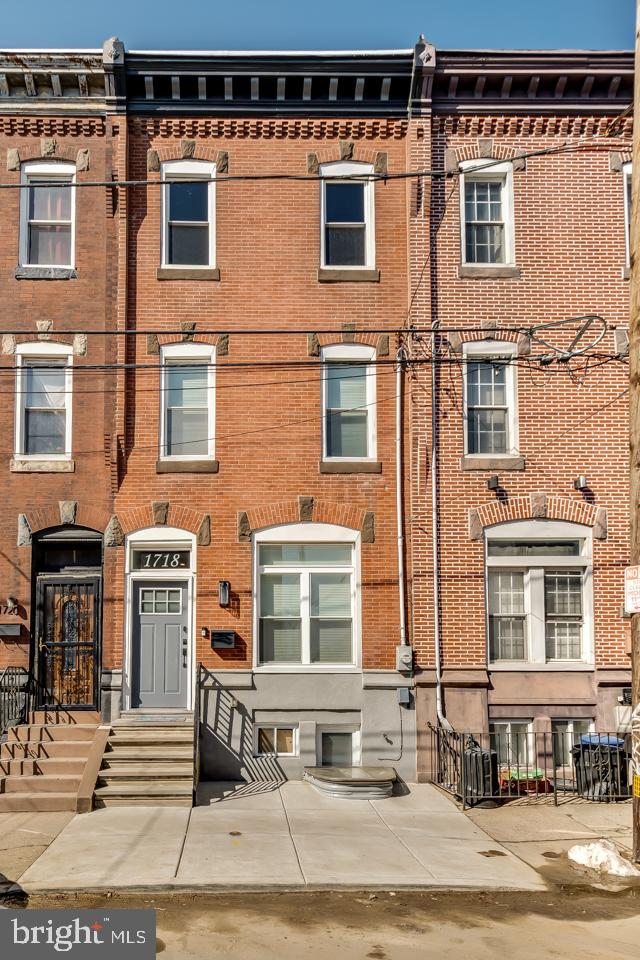 Welcome to 1718 S. 18th Street, a stunning custom renovation in the highly sought-after Newbold section of South Philadelphia, with exceptional modern finishes throughout. Highlighting approximately 6 years remaining on the improved value tax abatement, the new buyer will receive significant additional savings. This extra-wide, three-story home features 3 bedrooms, 3.5 baths, including two en-suite bedrooms, soaring ceilings, wide-plank solid oak flooring, and abundant natural light.
Designed for modern living and entertaining, the open-concept main level offers a beautifully appointed kitchen with ample cabinetry and storage, a stylish powder room, and seamless access to a spacious rear patio finished in new concrete. The second-floor features two spacious bedrooms, two full baths, a convenient laundry, and a custom wet bar. The entire third floor is dedicated to the primary suite, complete with a spa-inspired bath featuring an oversized shower, double vanity, and direct access to a bi-level Trex roof deck with breathtaking 360-degree skyline views.
Additional highlights include a fully finished, waterproofed basement with a French drain system and egress, two-zone high-efficiency HVAC, smart thermostats, abundant closet space in every room, which is a rarity in a townhouse, two washer/dryer hookups, and a SimpliSafe security system. Ideally located near the Broad Street Line, East Passyunk, and neighborhood favorites including Ultimo Coffee, South Philly Tap Room, Hardena, and Second District Brewing, this home offers the perfect blend of space, style, and convenience in one of Philadelphia’s most vibrant neighborhoods.